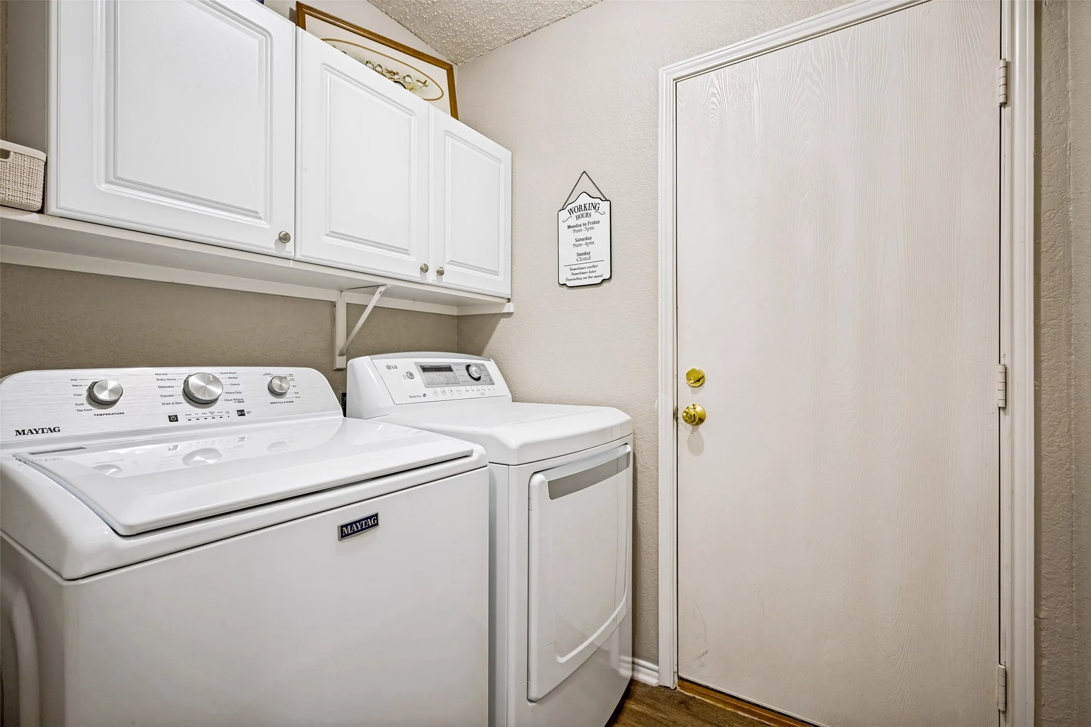 Utility room has built-in cabinets and shelf for more storage.