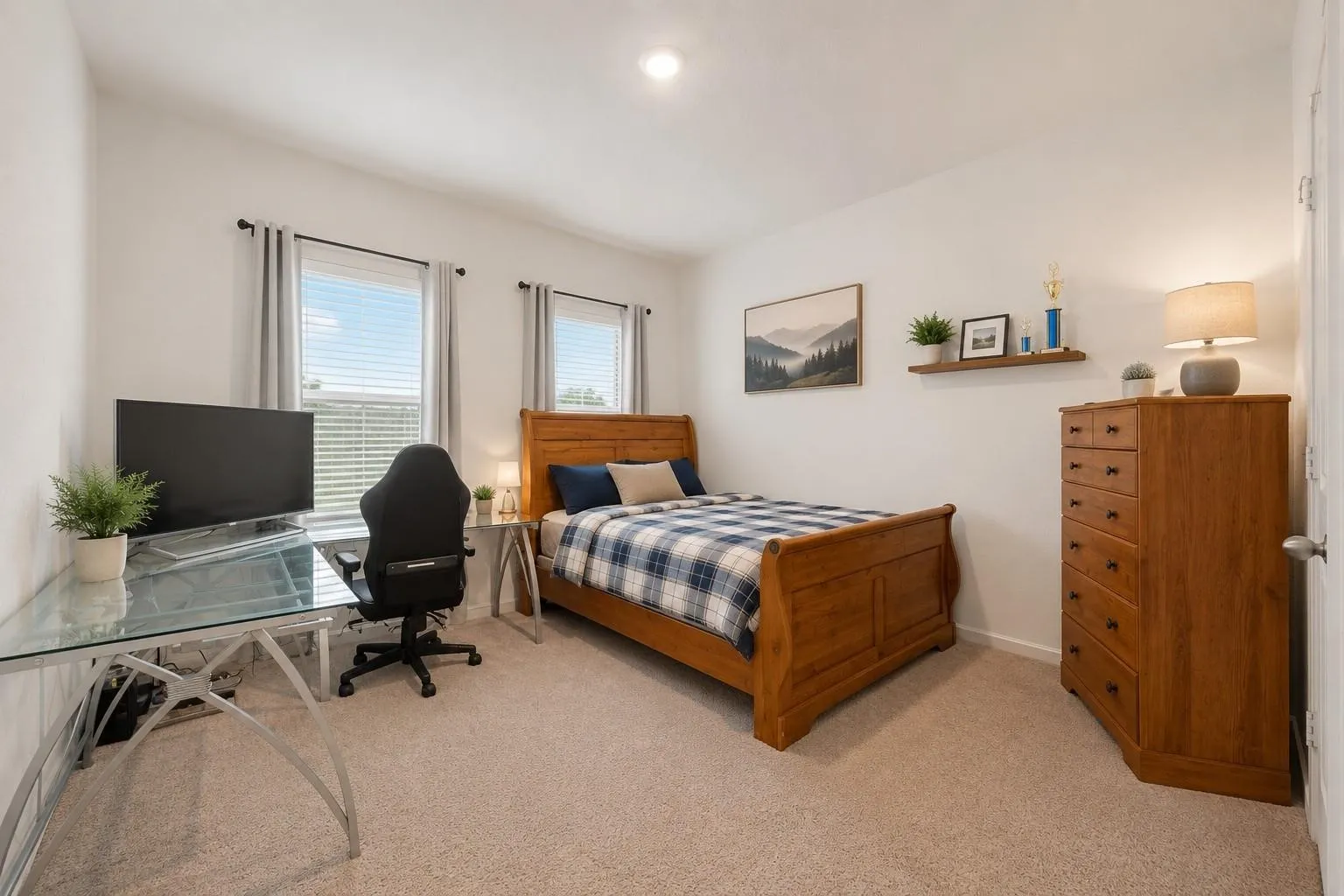 Spacious bedroom with neutral carpet, large windows for natural light, and ample room for furnishings.