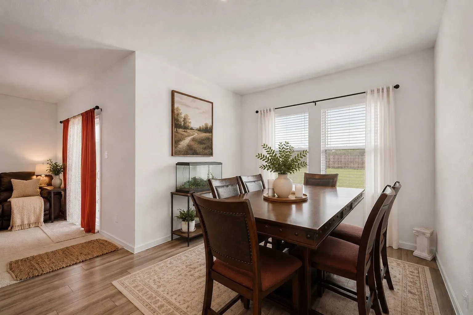 Second dining area view showcasing the open flow between the kitchen and living spaces, ideal for modern everyday living. Decor is Virtually Staged