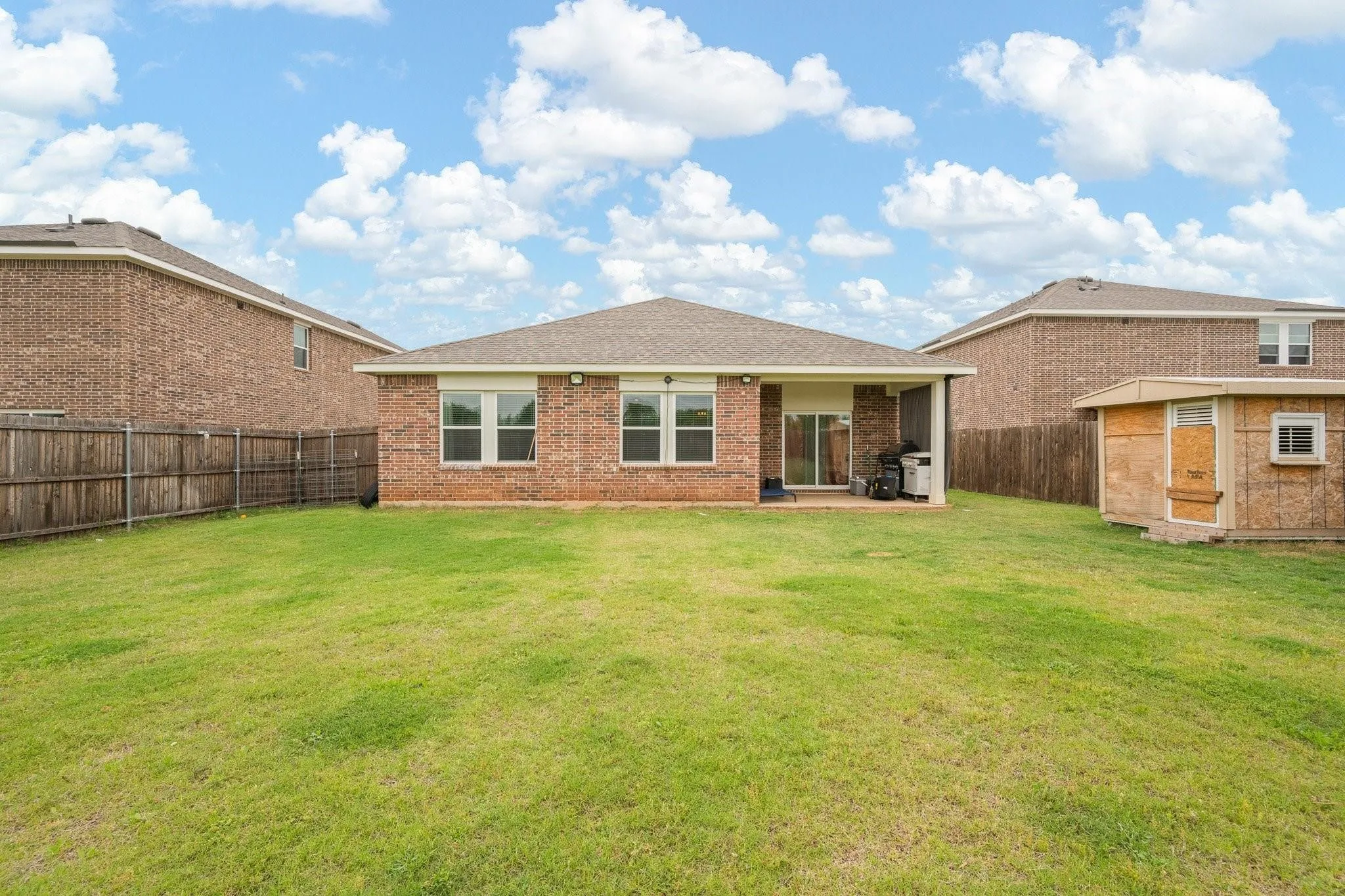 Second yard view highlighting the generous lot size, well-maintained lawn, and wide-open outdoor living potential.