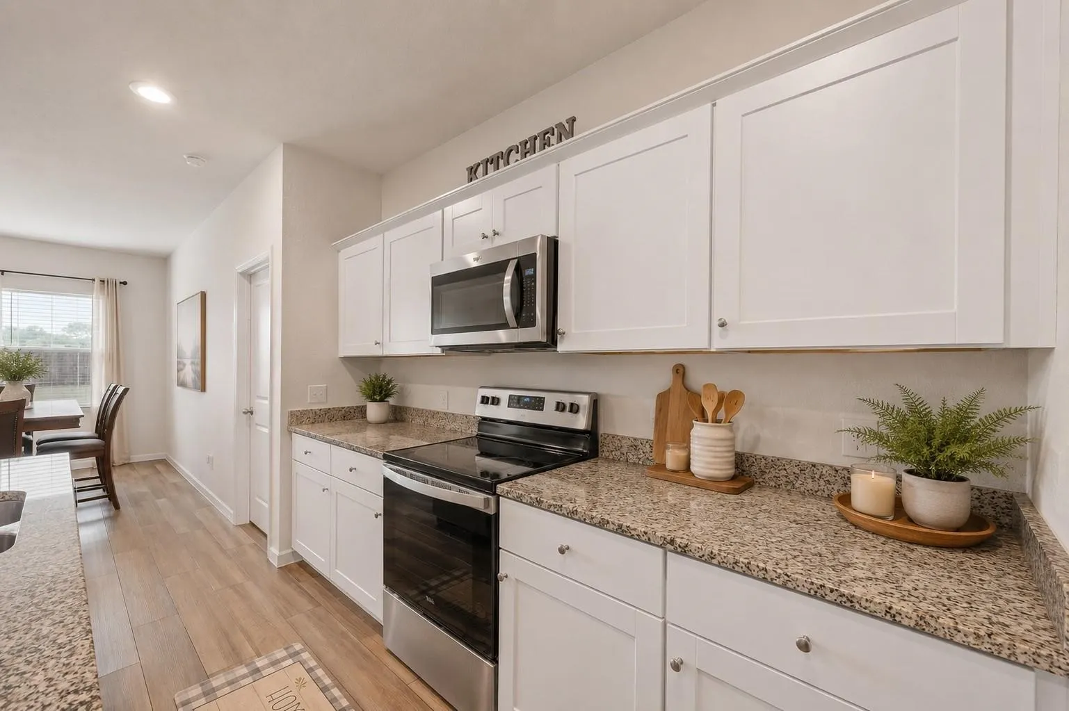 Kitchen view demonstrating the generous layout, ample storage, and quality finishes throughout this chef-ready space. Decor is Virtually Staged
