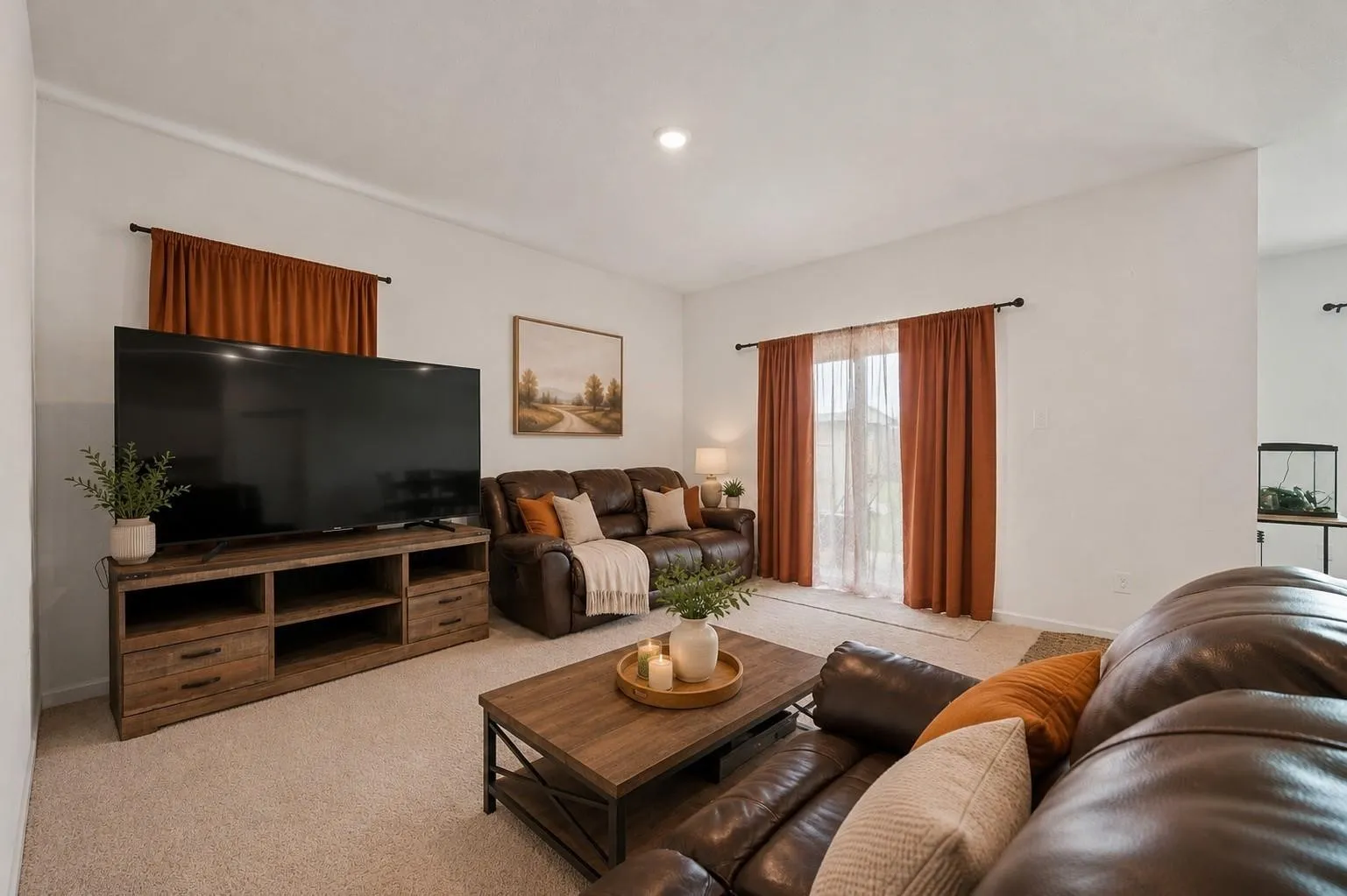 Second living room view showcasing the generous square footage, bold accent curtains, and connection to the entertainment area. Decor is Virtually Staged
