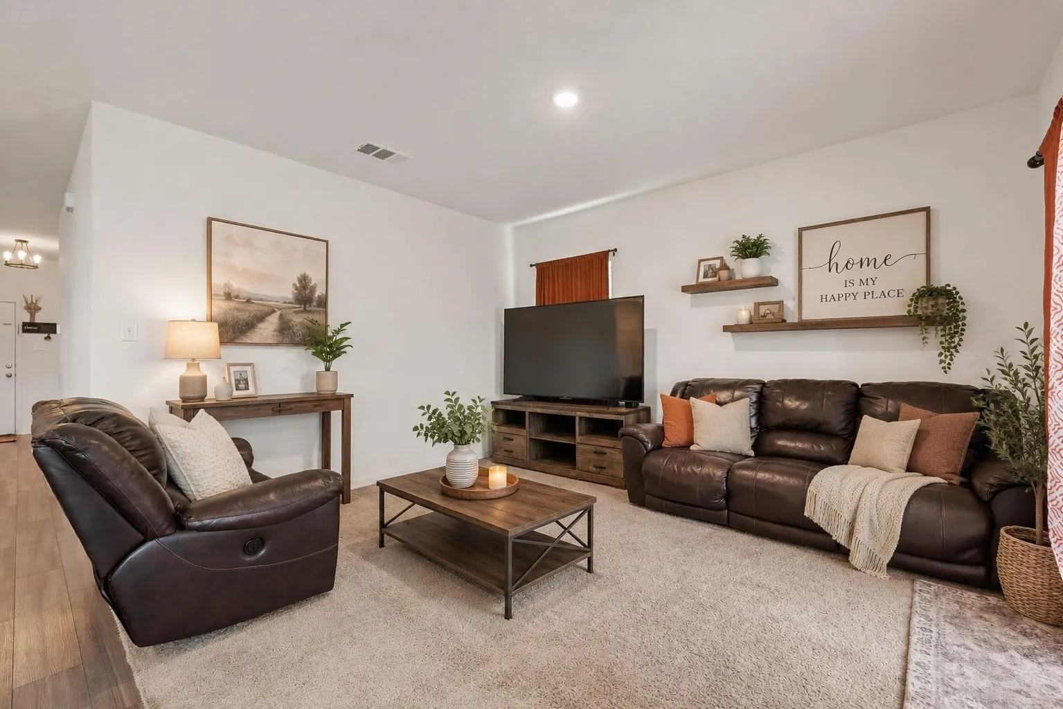 Virtually Staged — Spacious living room with neutral carpet, plush seating, and an open layout perfect for everyday living and entertaining.