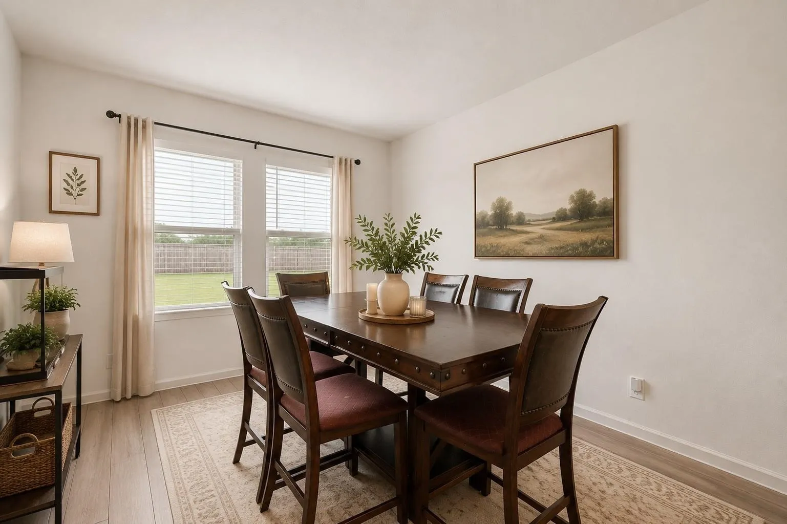 Bright dining area with large windows overlooking the backyard, perfect for everyday meals and entertaining guests. Some virtual staging was used.
