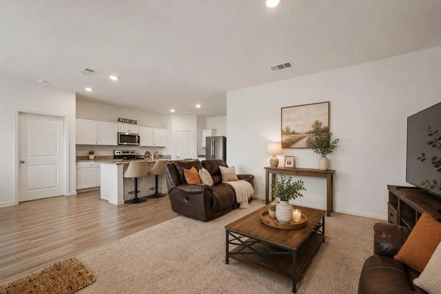 Virtually Staged — Wide living room view demonstrating the seamless sight line from the living area through to the kitchen, ideal for modern living.
