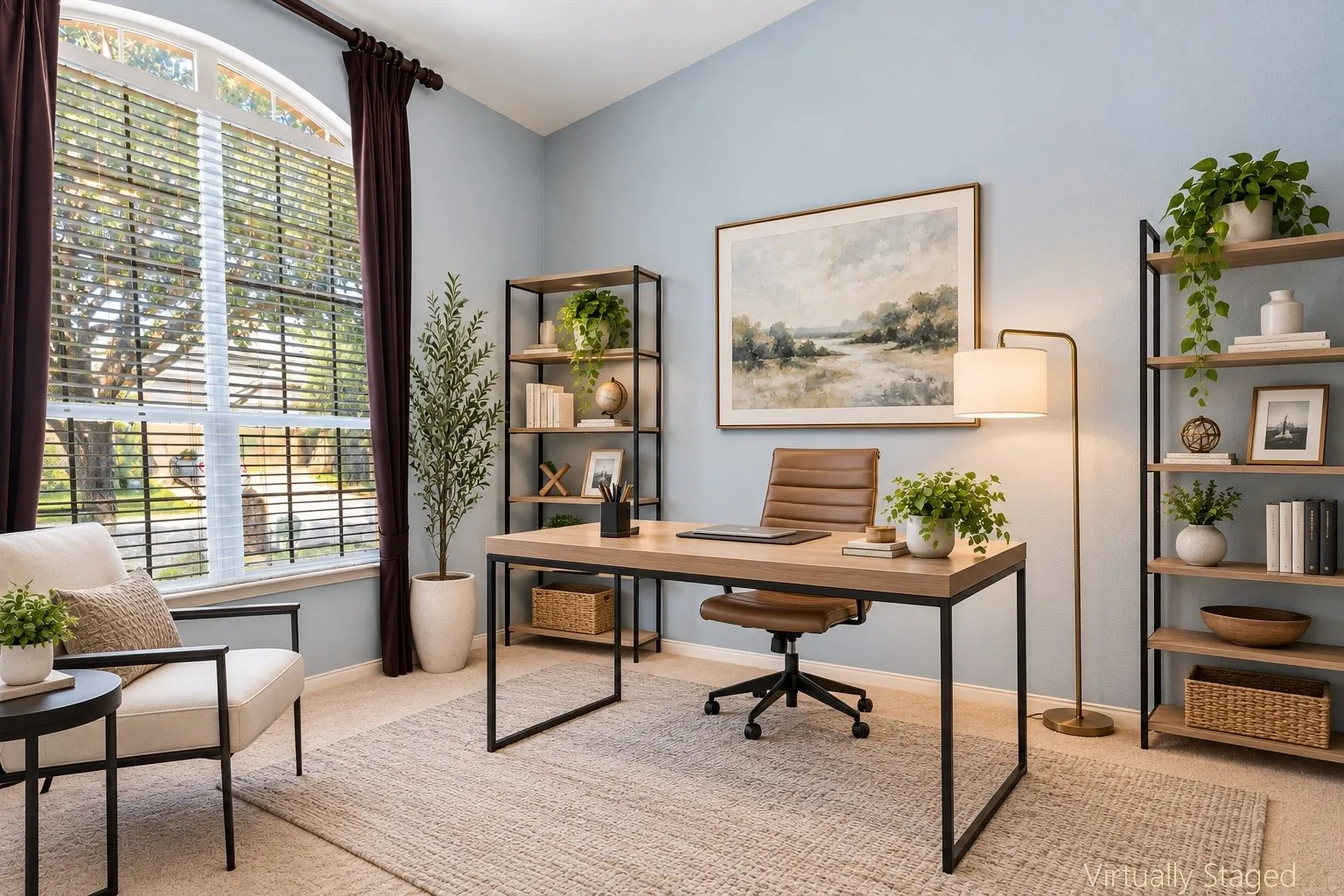 Arched window with blinds, wood-finish flooring, two built-in shelving units, and light blue wall finish