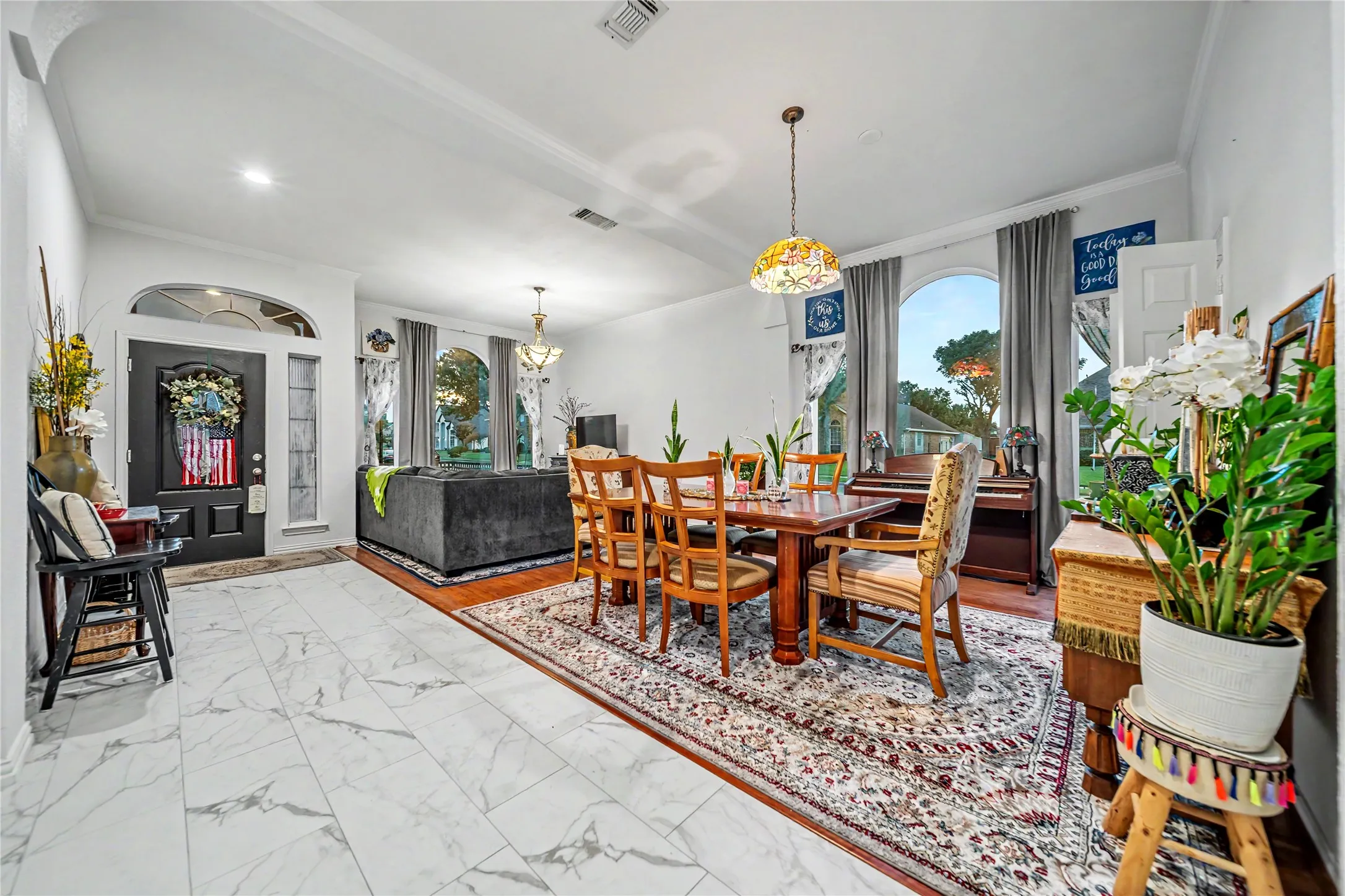Bright interior featuring white walls and crown molding