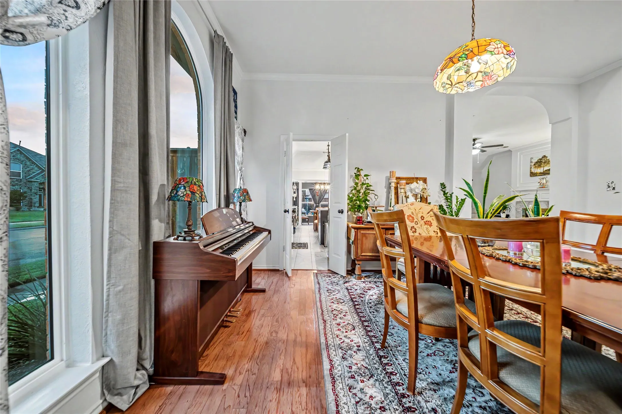 Dining area featuring wood-finish flooring and an arched doorway