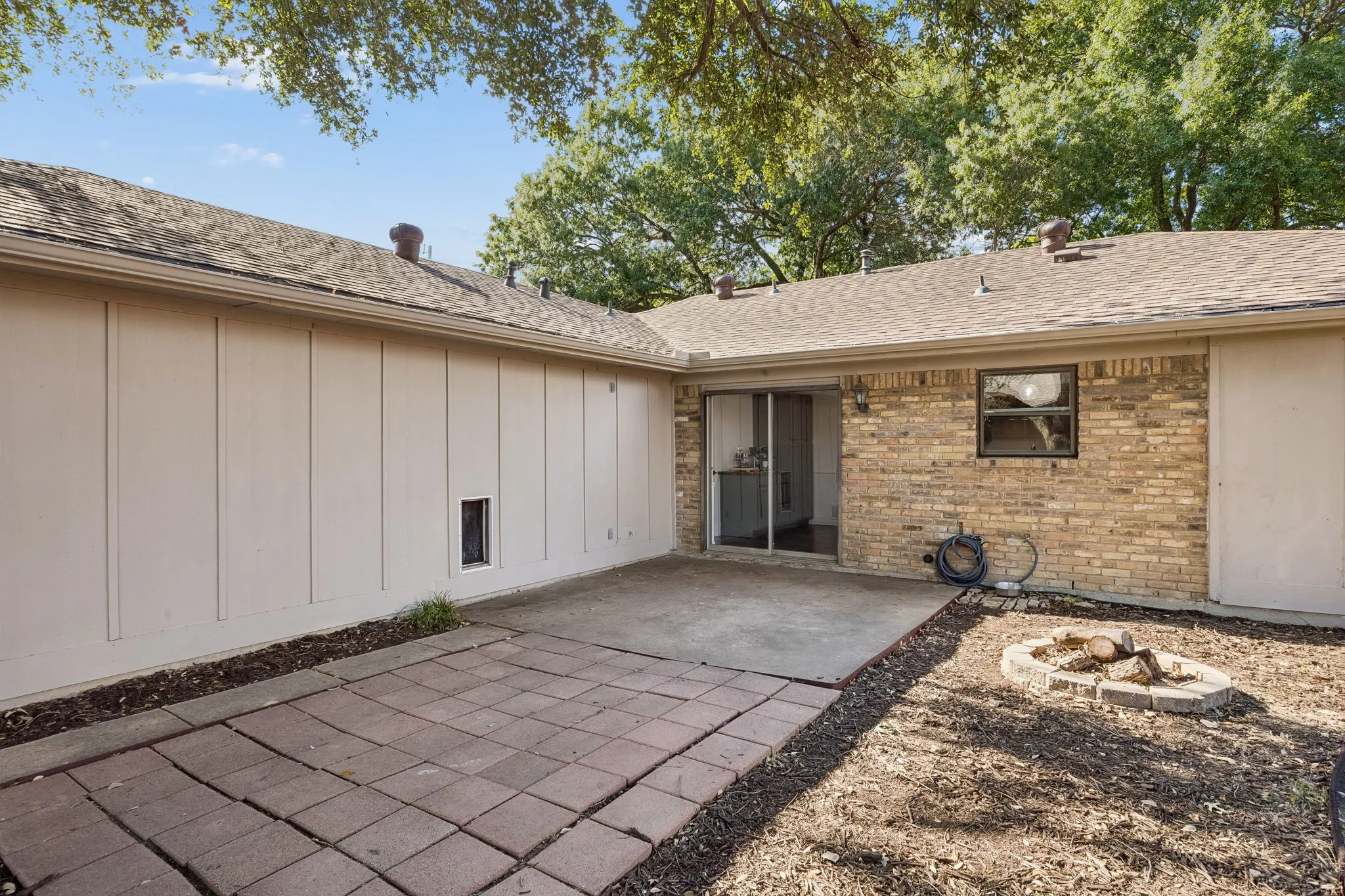 The backyard offers substantial patio space, a mature tree, privacy fencing and room for the next owner to personalize the landscape.