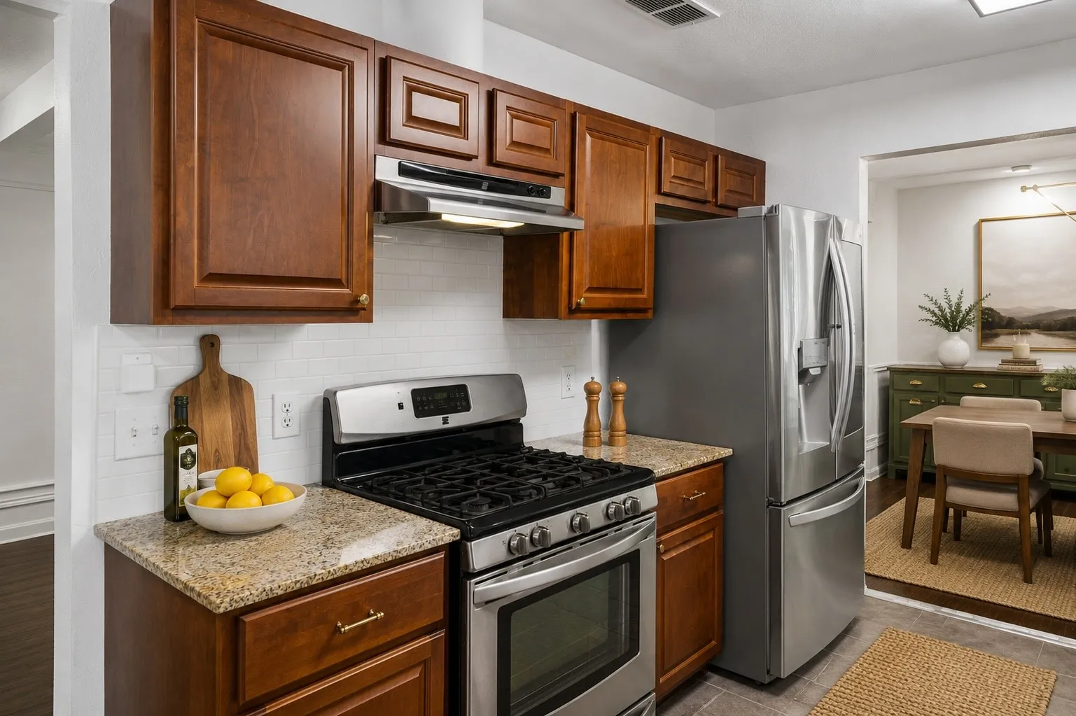 Granite countertops, stainless steel appliances and a classic white subway tile backsplash create a functional foundation for everyday cooking.
Virtually Staged -- original image may have been altered by AI.