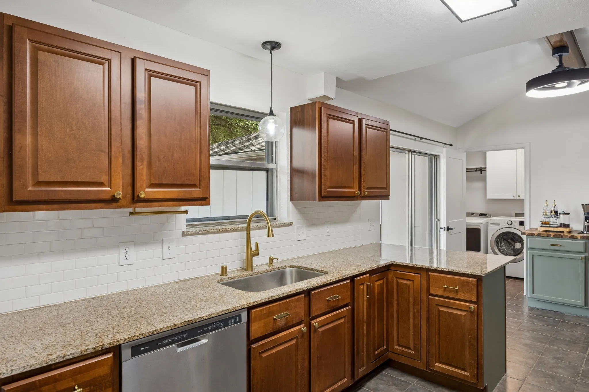The granite-topped peninsula adds valuable preparation space, additional storage and a comfortable spot for casual meals.