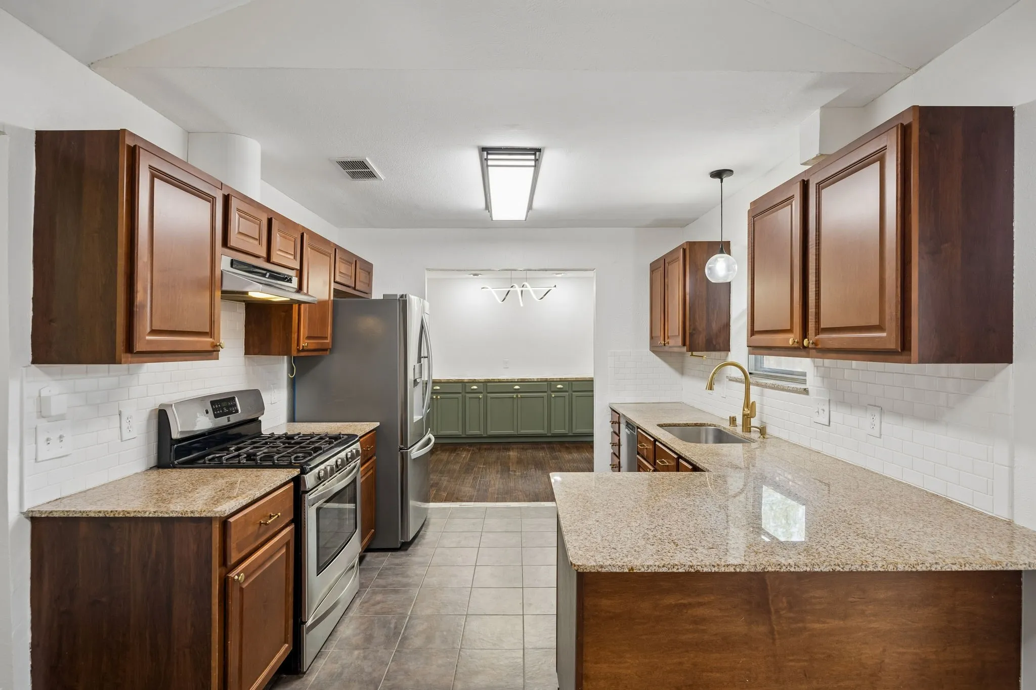 Generous counter space and an open connection to the breakfast area support both daily functionality and gatherings with guests.