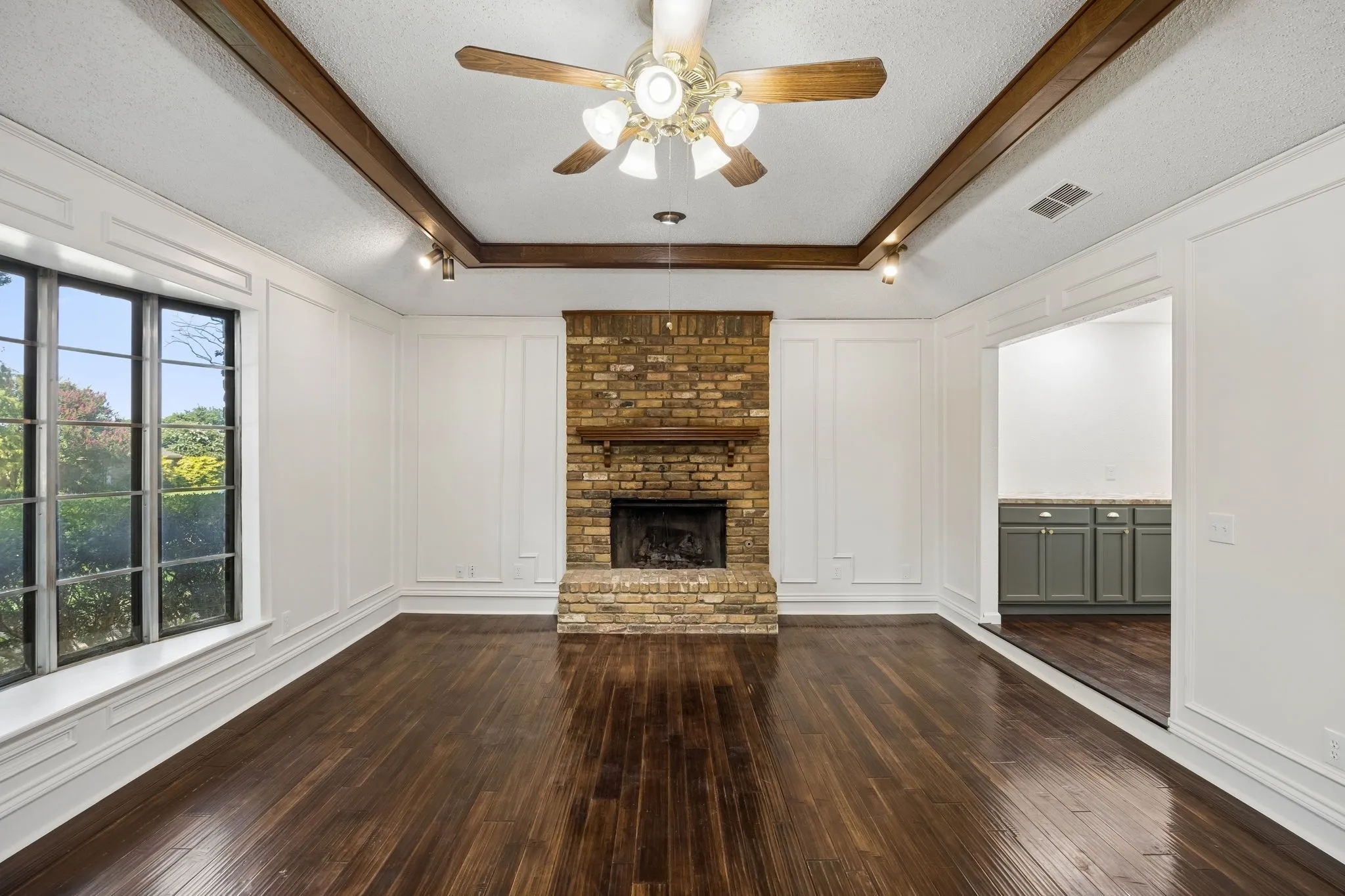 The spacious family room offers a dramatic fireplace focal point and a flexible layout ready to reflect the next owner’s style.