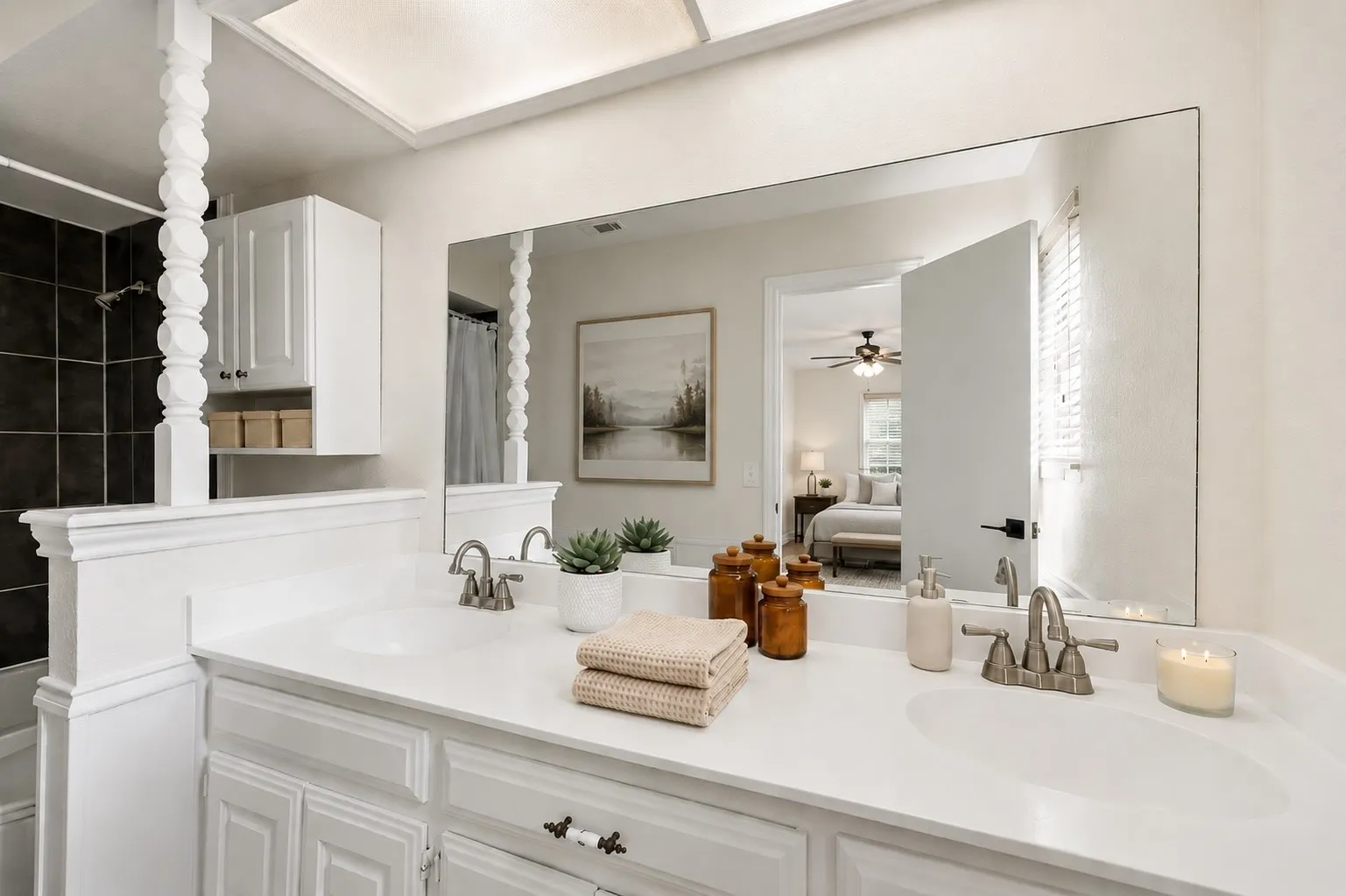 The refreshed primary bath features painted cabinetry, resurfaced countertops, updated flooring and a bright, cohesive finish palette.
Virtually Staged -- original image may have been altered by AI.