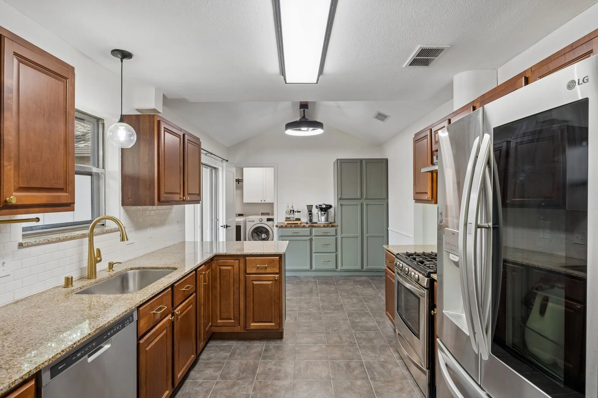 Natural light and backyard views brighten the kitchen, while the peninsula provides casual seating for two.