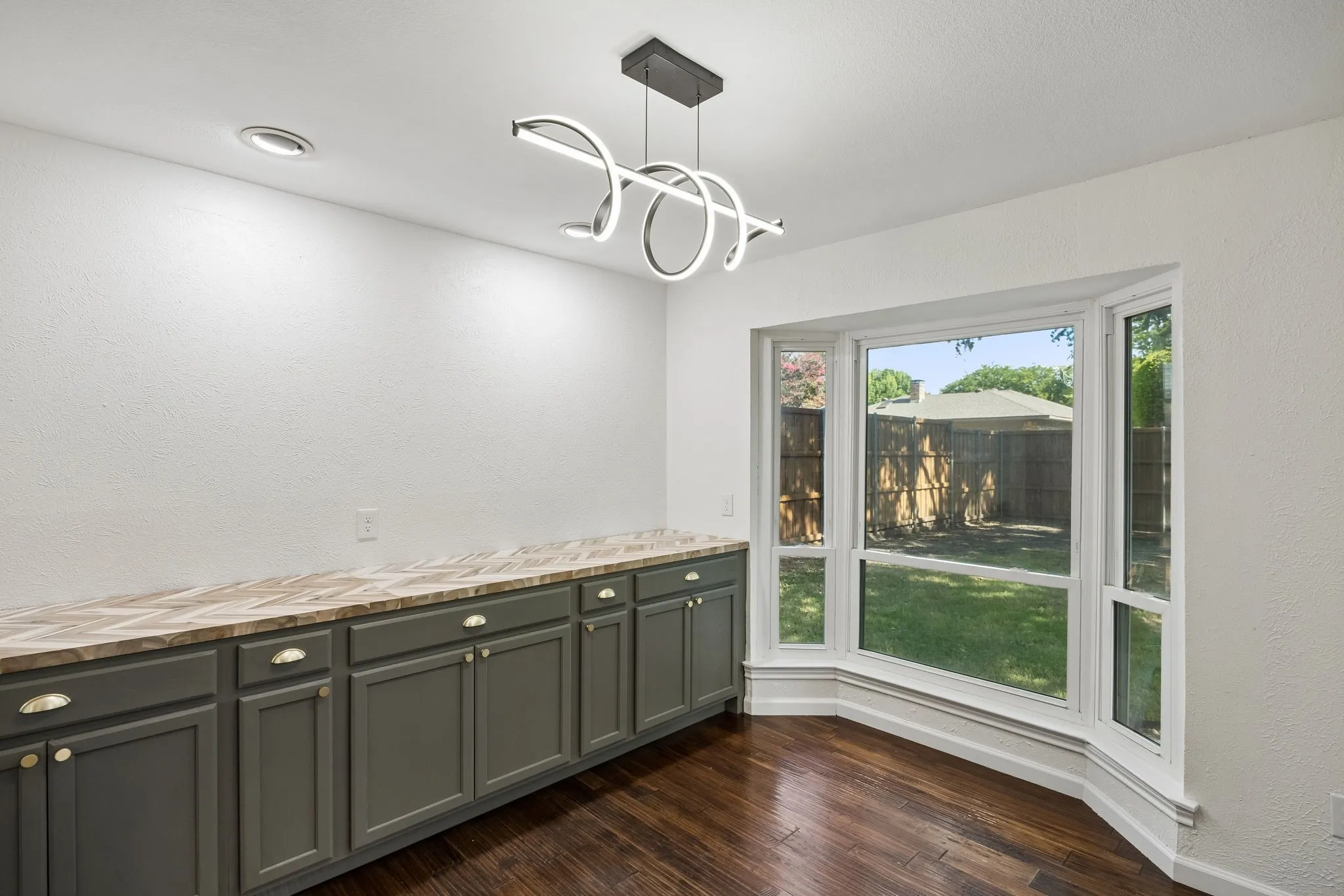 Custom cabinetry creates a functional serving area while preserving ample room for a full dining table.