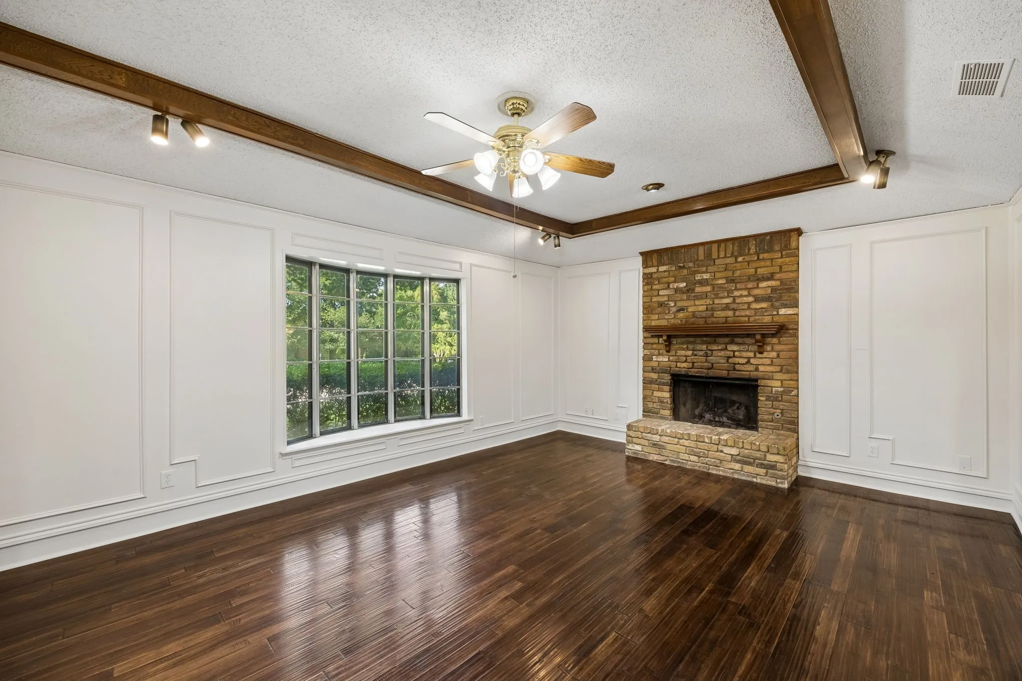 Vaulted ceilings and substantial wood beams add dimension and timeless architectural interest to the family room.