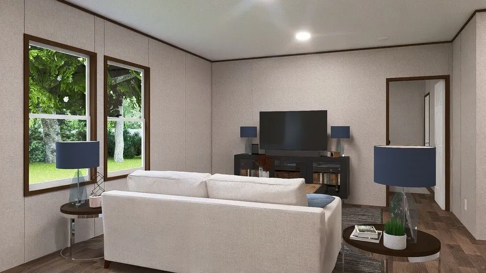 Spacious living area featuring wood-finish flooring, two large windows with dark wood trim, recessed ceiling lighting, and a doorway leading to an additional space