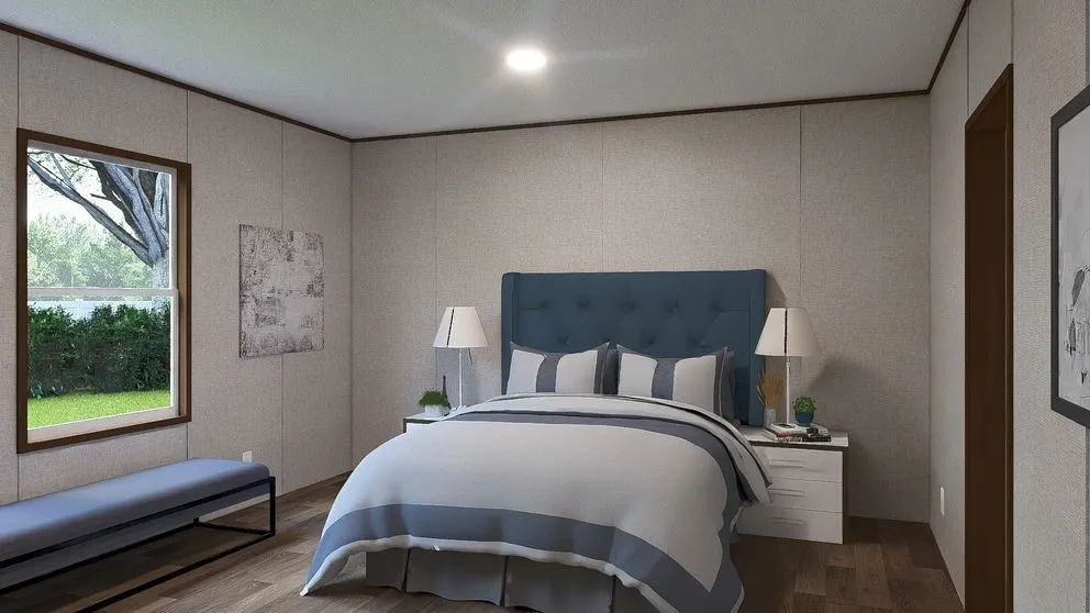 Spacious bedroom featuring wood-finish flooring, a large window with natural light, textured wall panels, and a recessed ceiling light