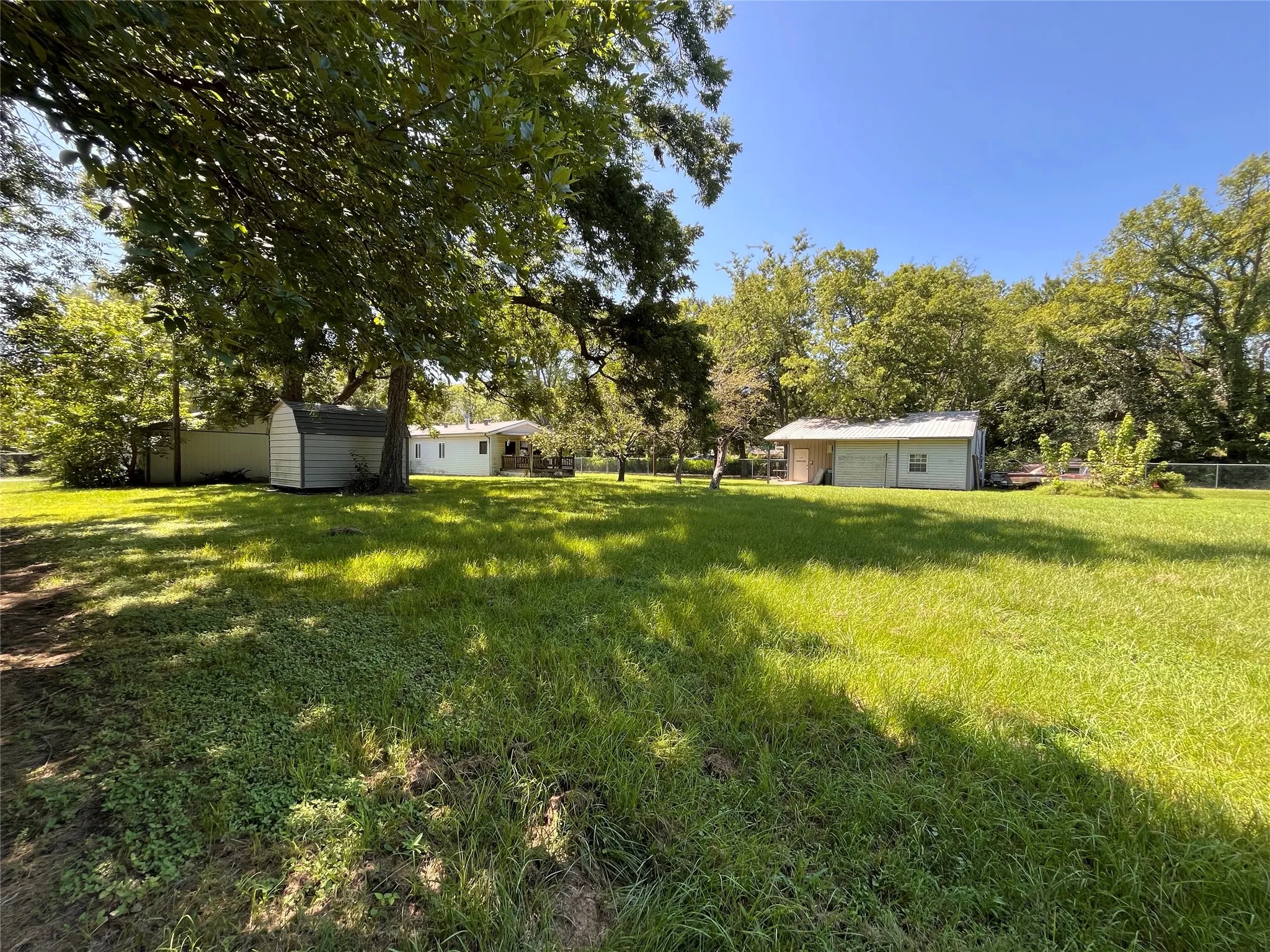 House, garage, shop, storage shed and still plenty of yard left!