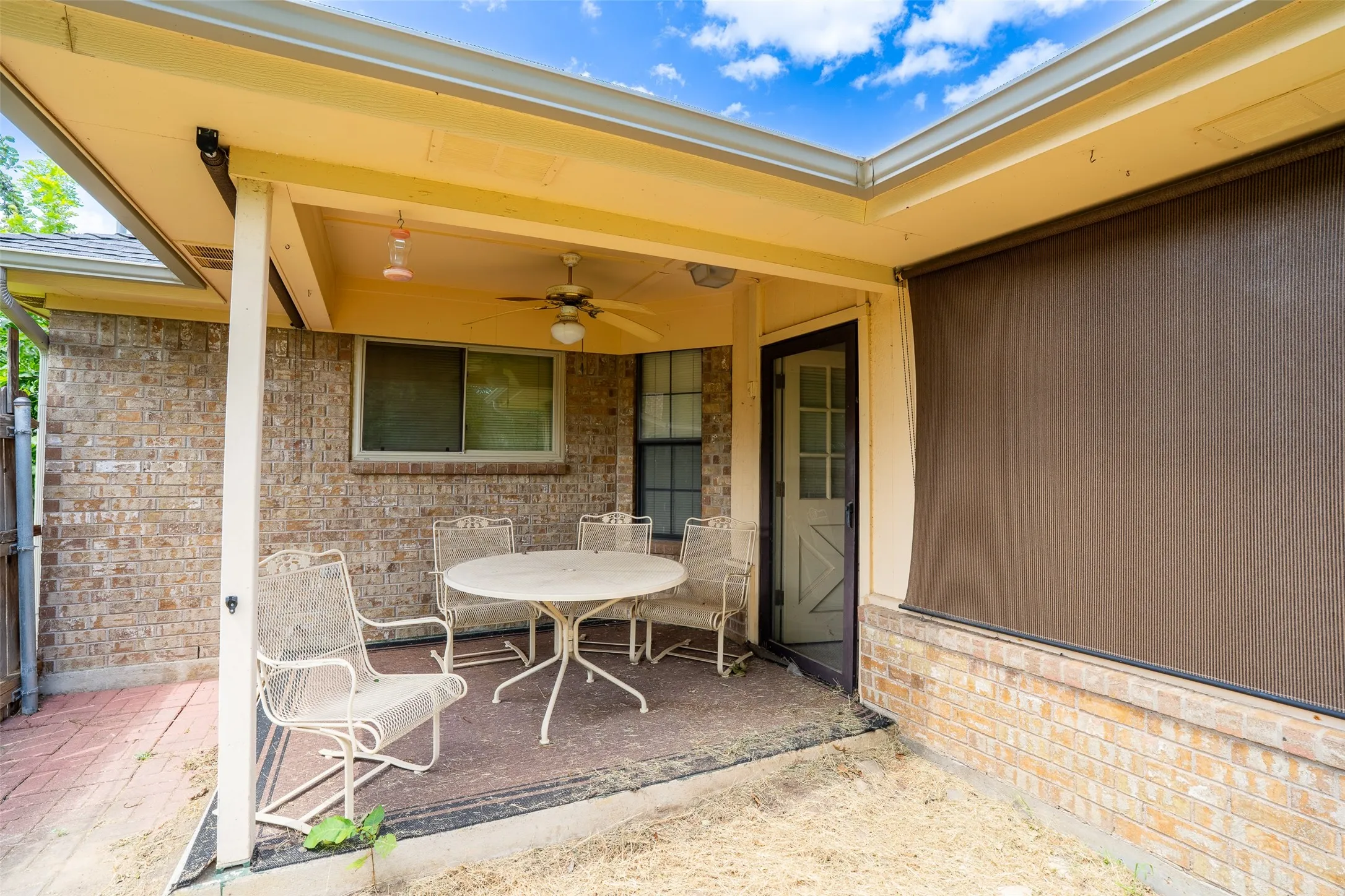 Covered patio with a ceiling fan and recessed lighting