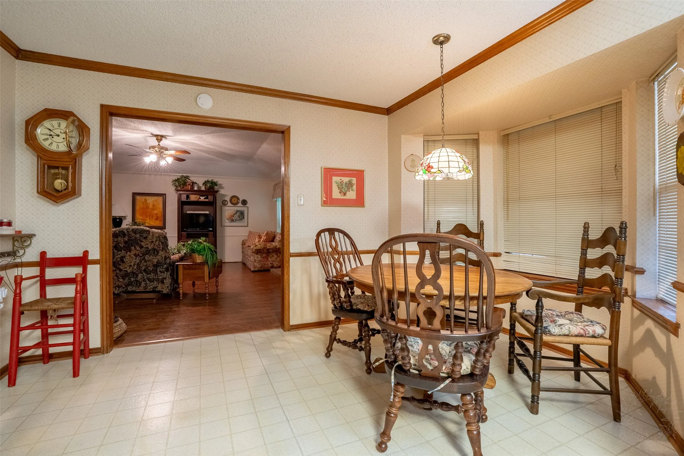 Dining area with patterned vinyl flooring and wood-finish trim