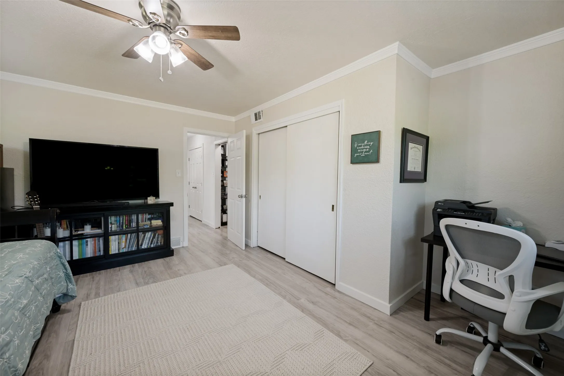 Neutral-toned room featuring light wood-finish flooring and white baseboards