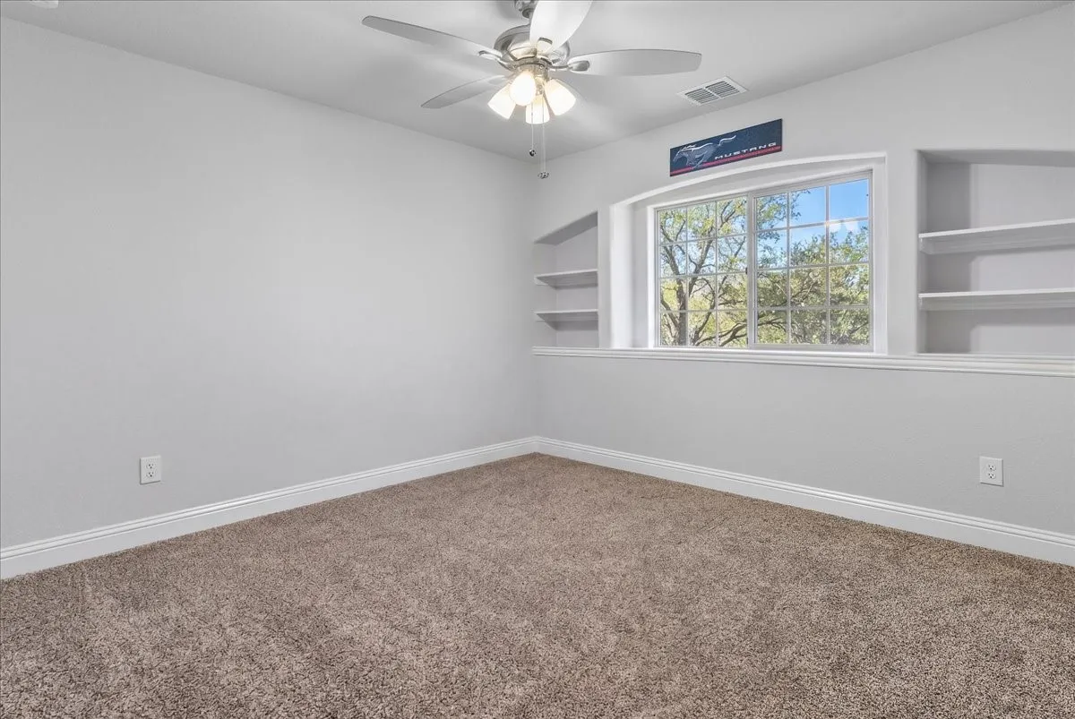 Recessed window with built-in shelving, providing natural light