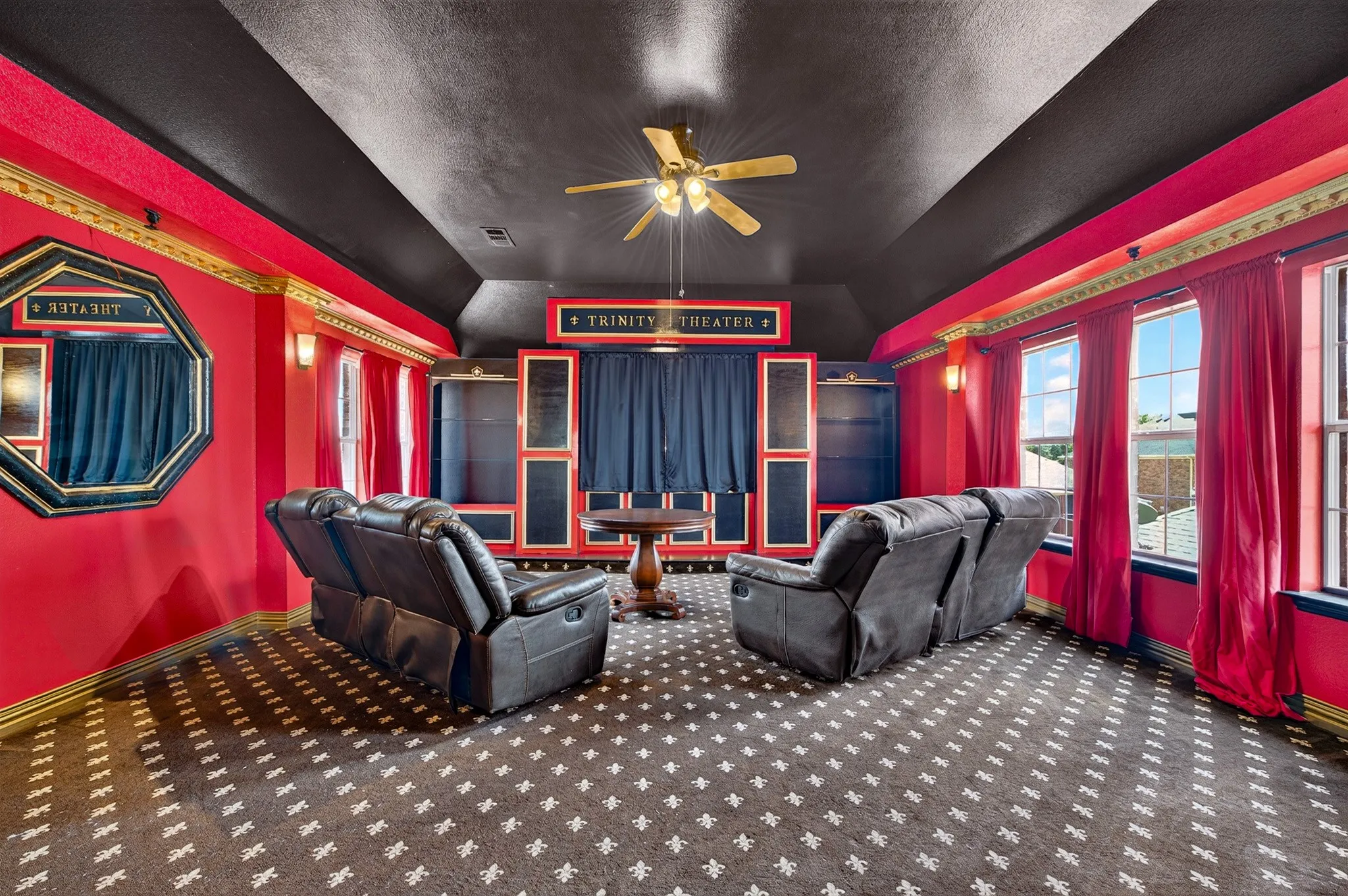 Dedicated entertainment space featuring a themed design with a dark ceiling and red walls