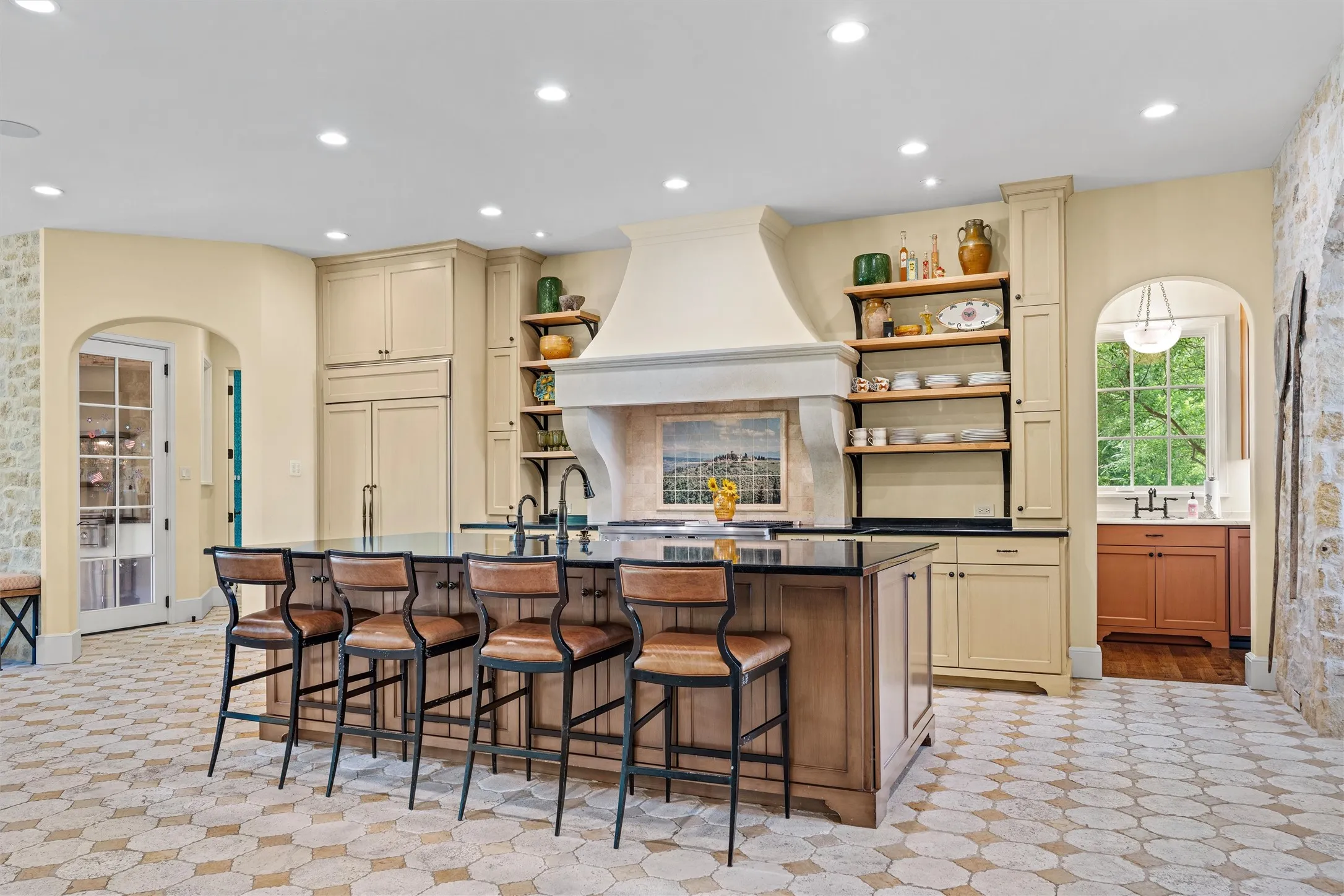Light and bright, the kitchen welcomes your family and friends to watch the master chef at work, with extra seating at the large island.