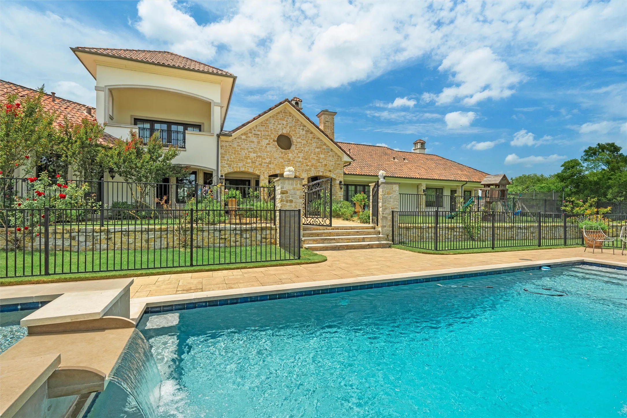 The oversized pool sparkles with dramatic waterfalls.  Ready for year-round use!