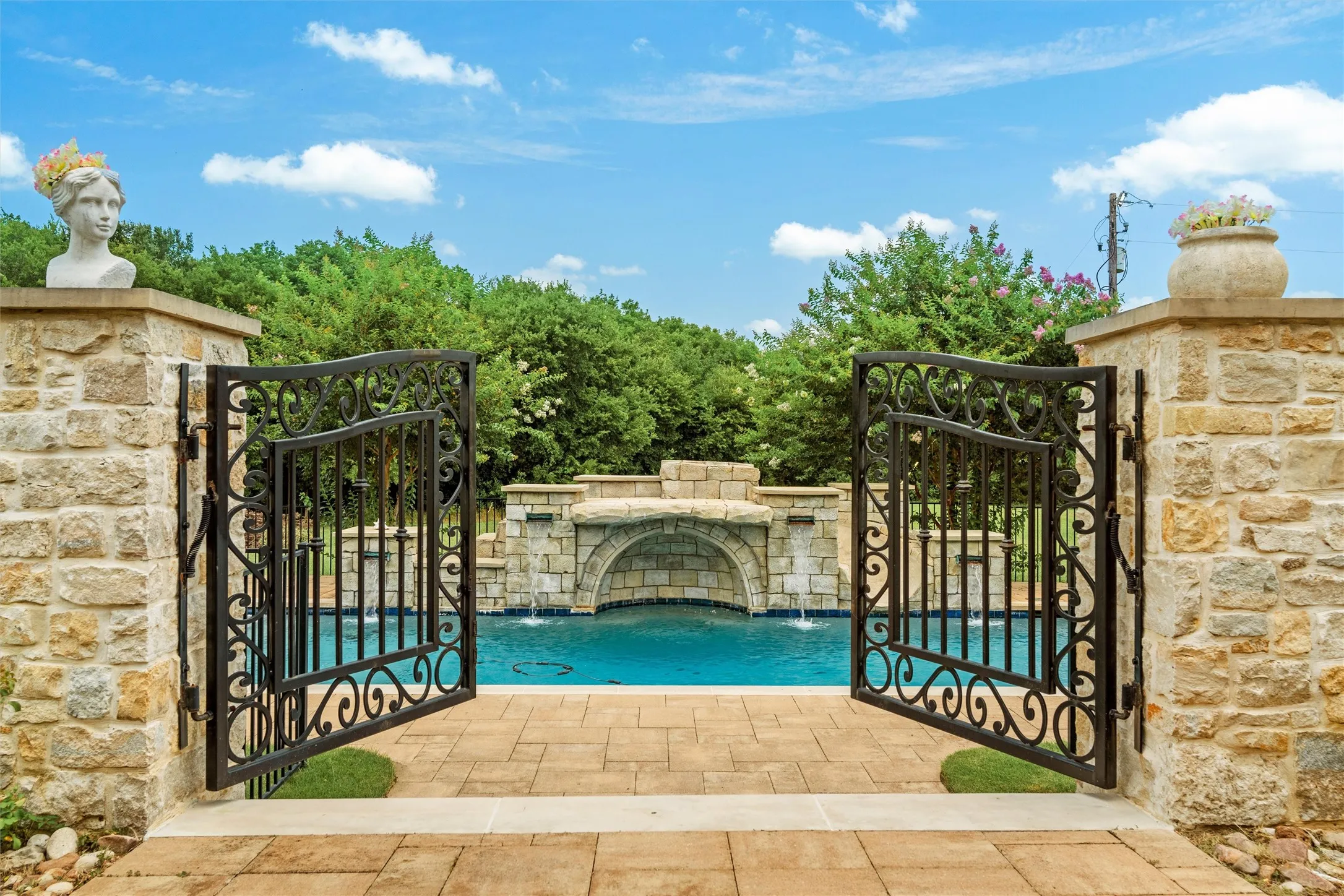 Upon entering the wrought iron gates, you feel as if you are in Tuscany, with the rough faced limestone surrounding the luxurious pool replete with waterfalls and a grotto.