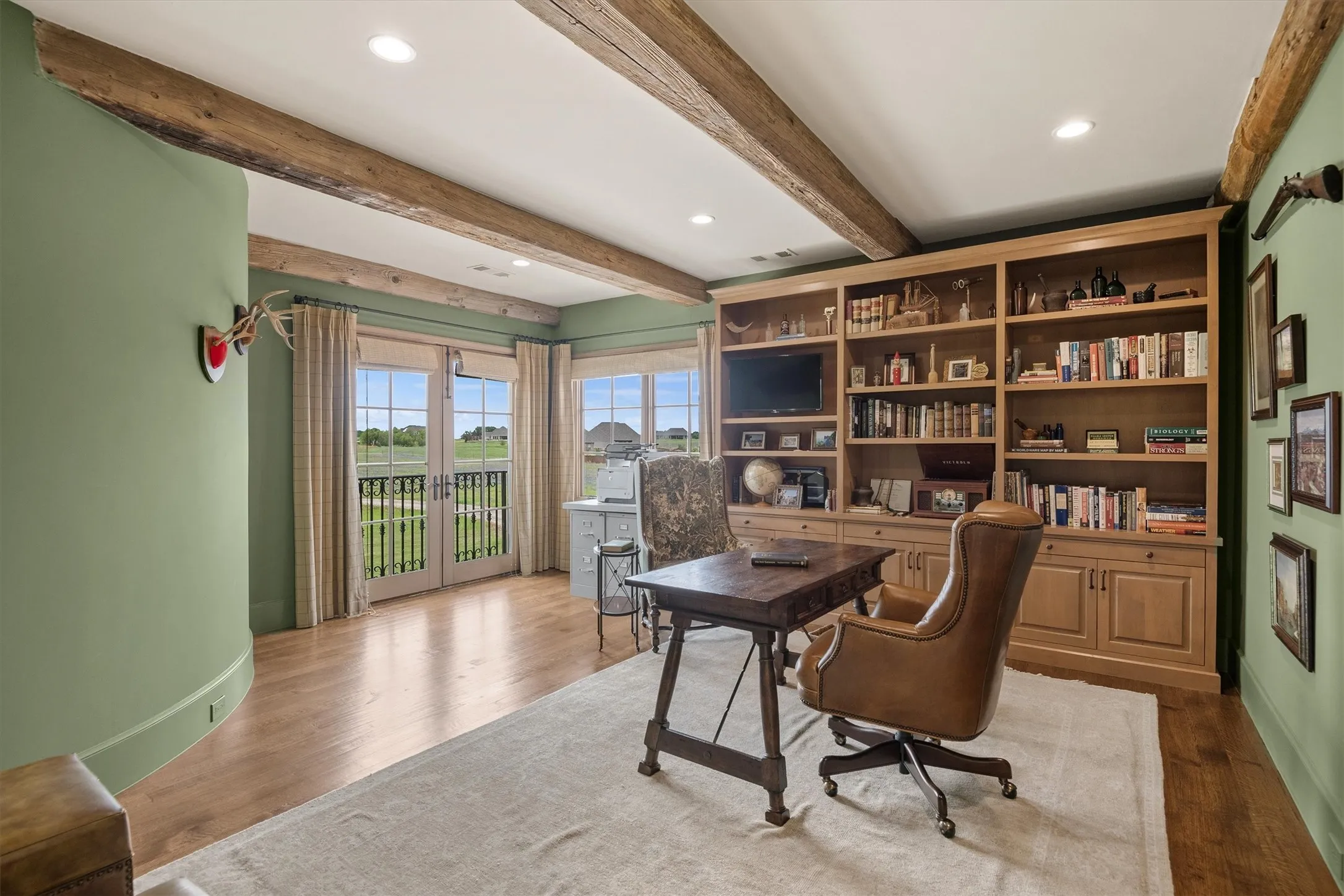 For the work at home spouse, the executive office is located on the second floor.  Continuing the theme of reclaimed wooden beams, the office provides a private, yet impressive space for conducting business.
