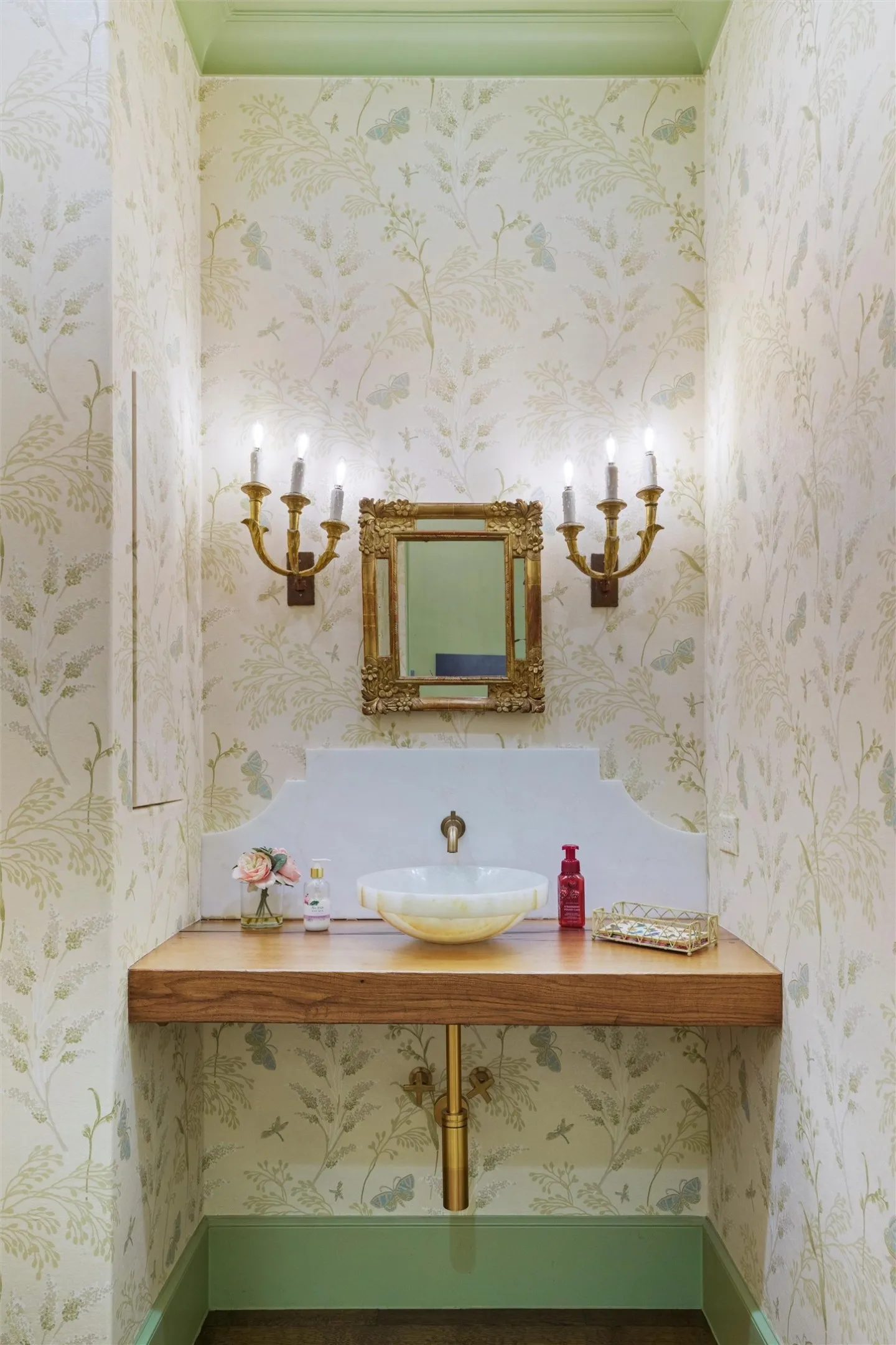 Designer wallpaper and designer lighting abound in the downstairs power bath.