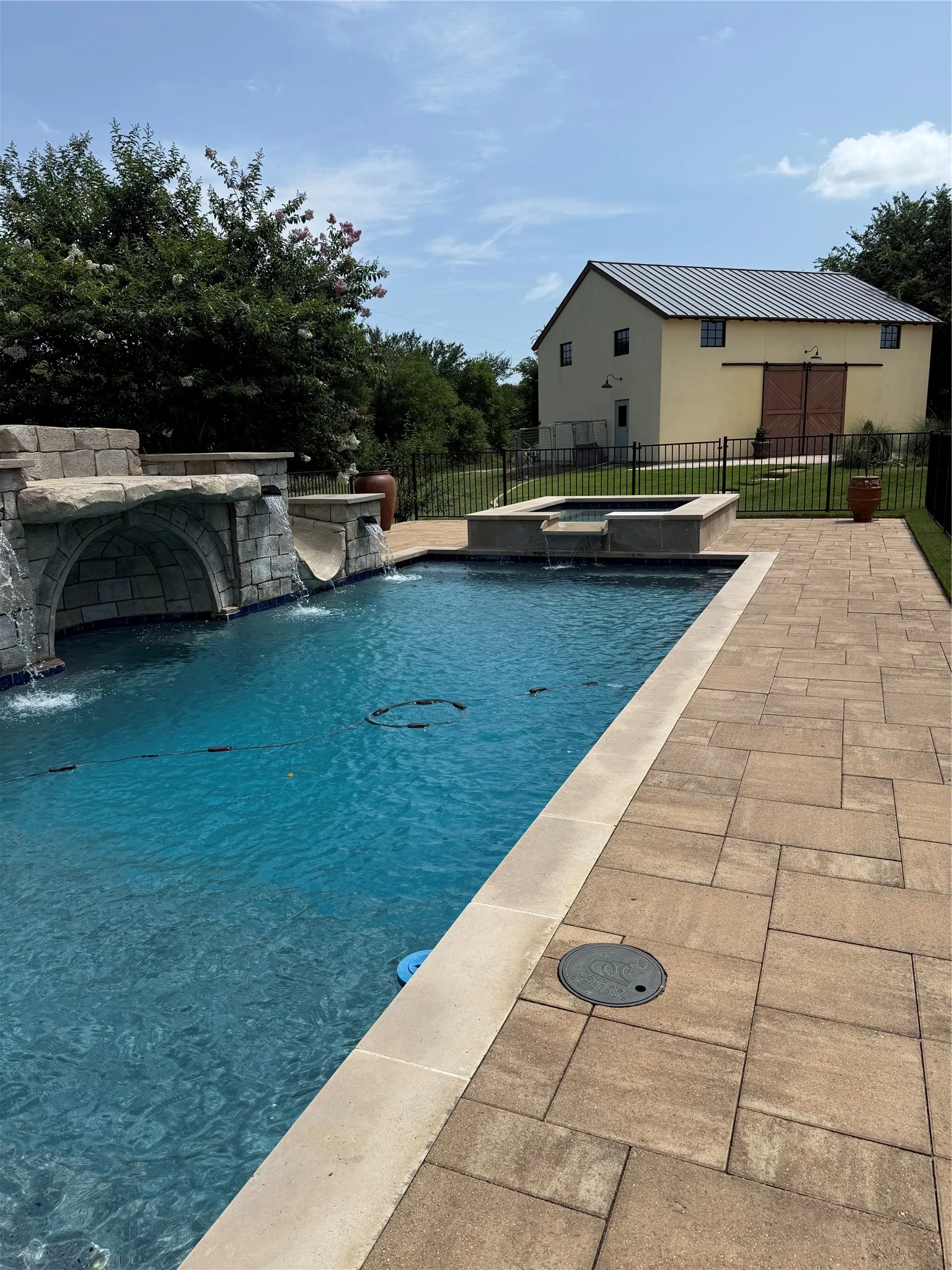 The waterfalls and grotto are inviting for the oversized pool!  And the separate spa is perfect for the cool days of fall and winter!