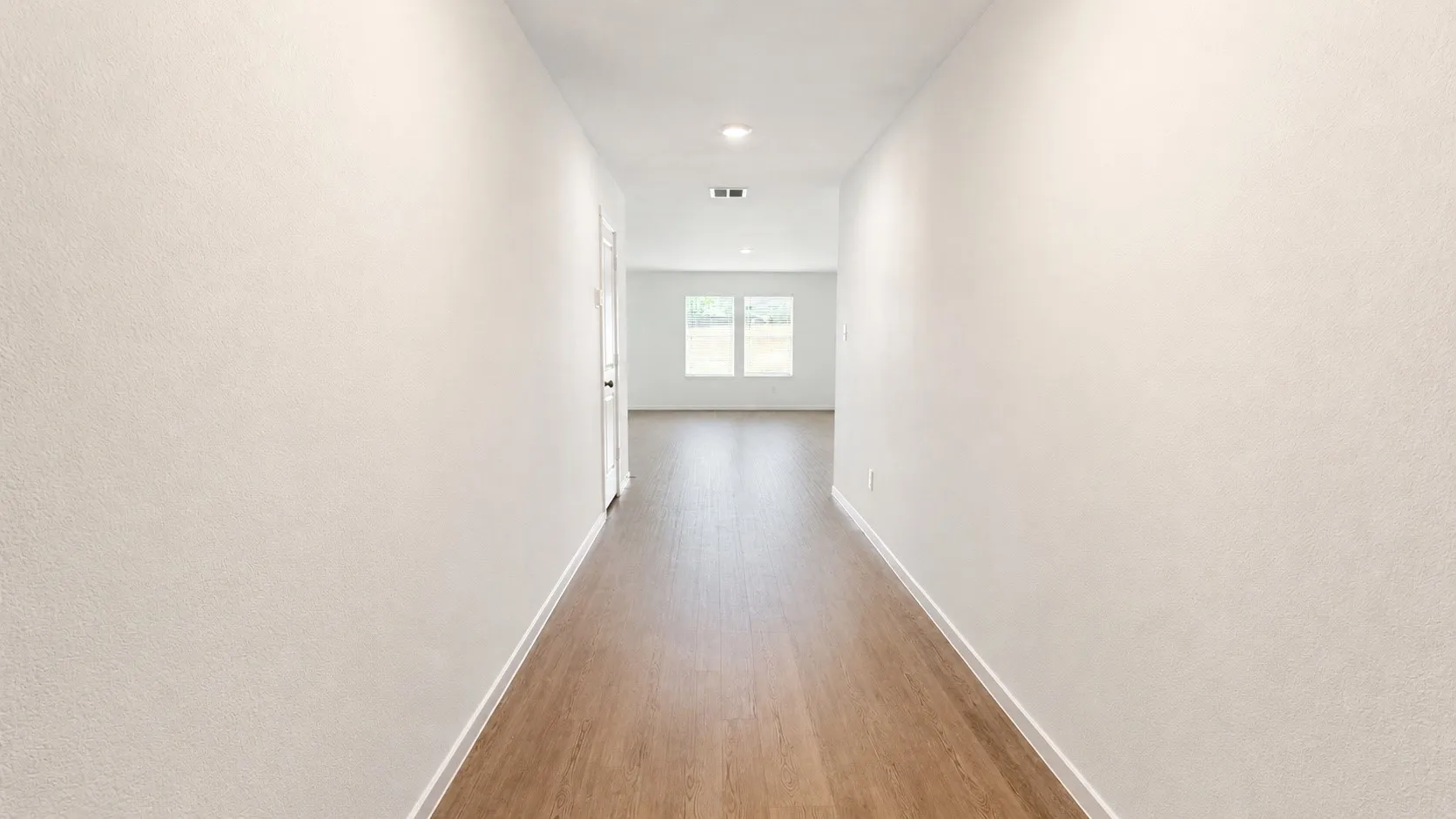 Hallway featuring wood-finish flooring and recessed lighting