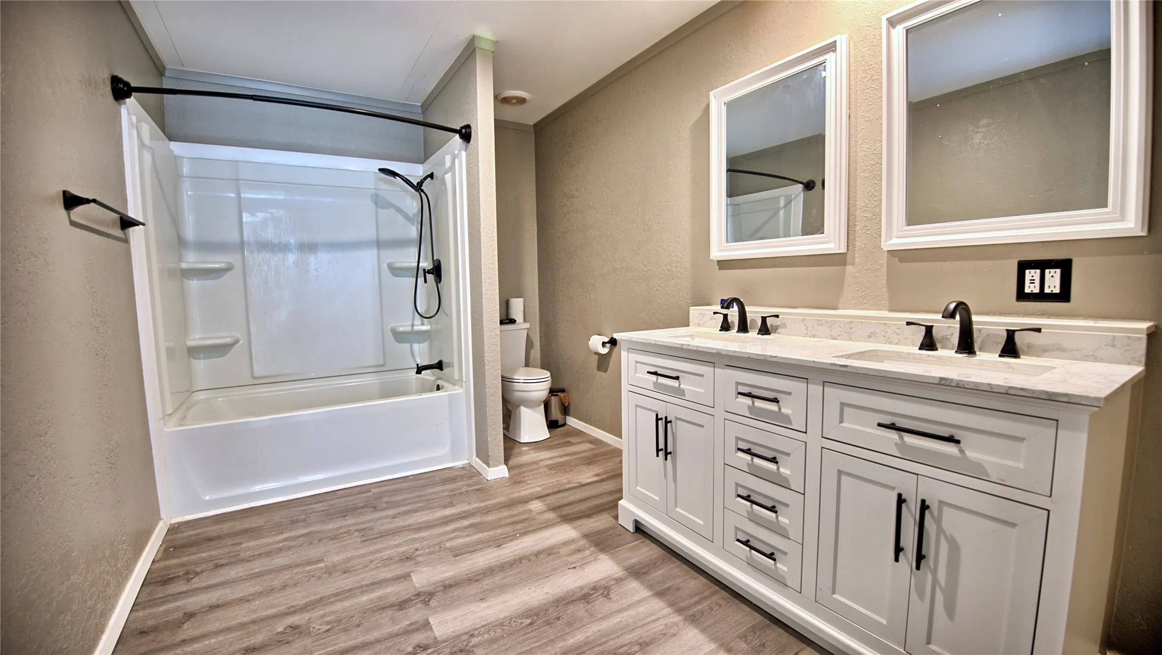 Primary Ensuite Bath  is spacious and features double sink vanity with tub shower combo