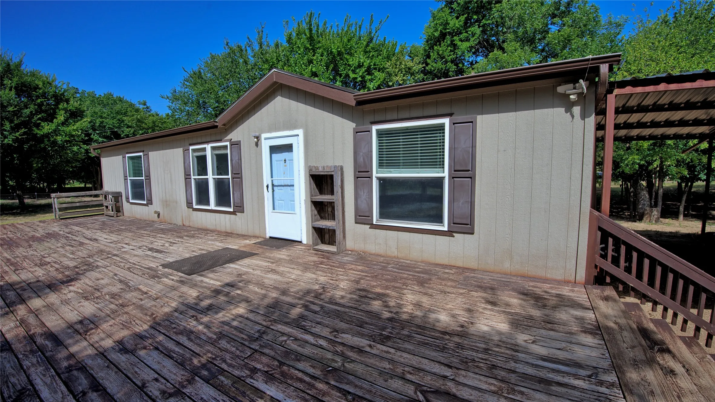 2019 3bed/2bath doublewide features front deck, carport, and back deck