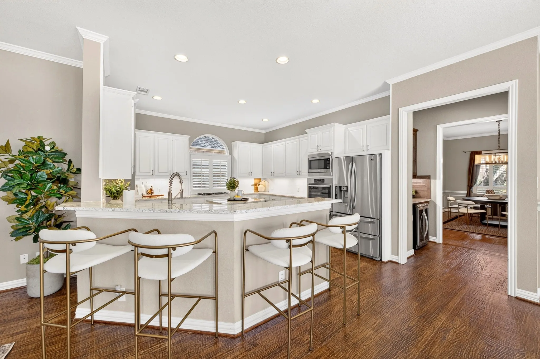 Kitchen featuring white cabinetry, stainless steel appliances, recessed lighting, and wood-finish flooring