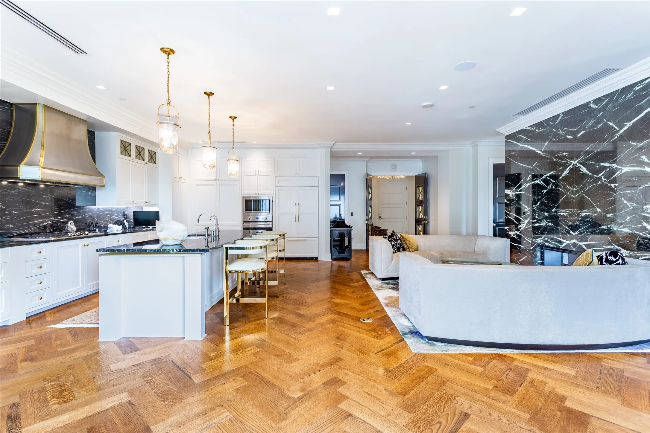 Herringbone patterned wood floors throughout the residence.