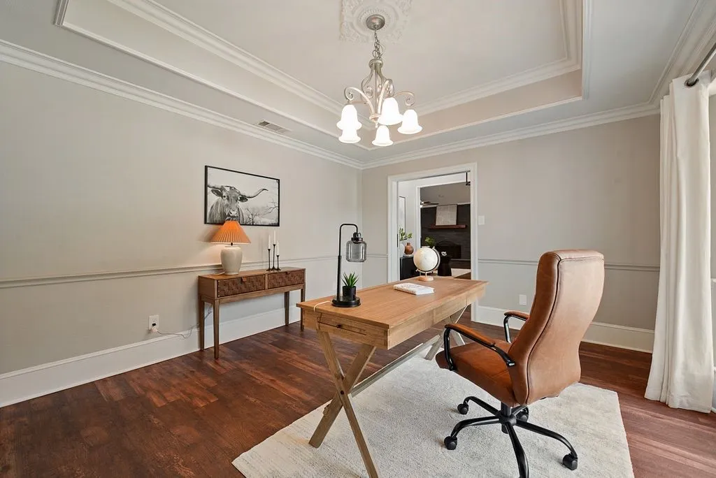 Coffered ceiling featuring a decorative chandelier and crown molding