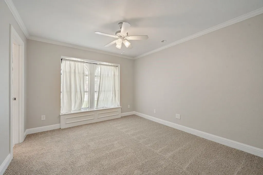 Bedroom complemented by crown molding and baseboards
