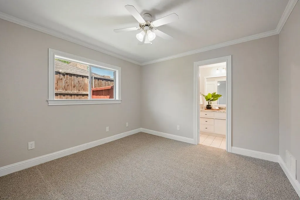 Bedroom complemented by crown molding and baseboards