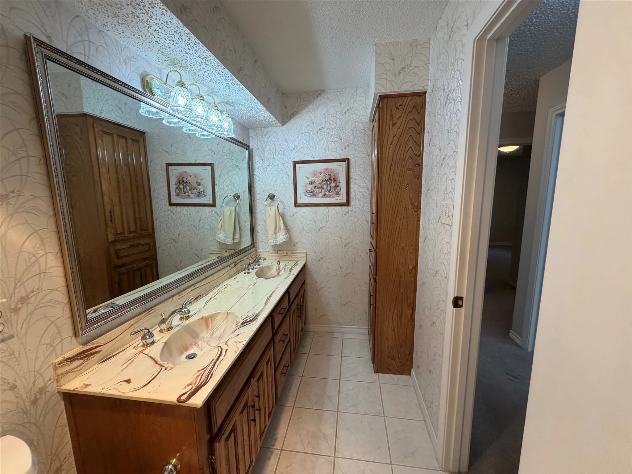 Hall bath with dual sinks, hamper and linen cabinet