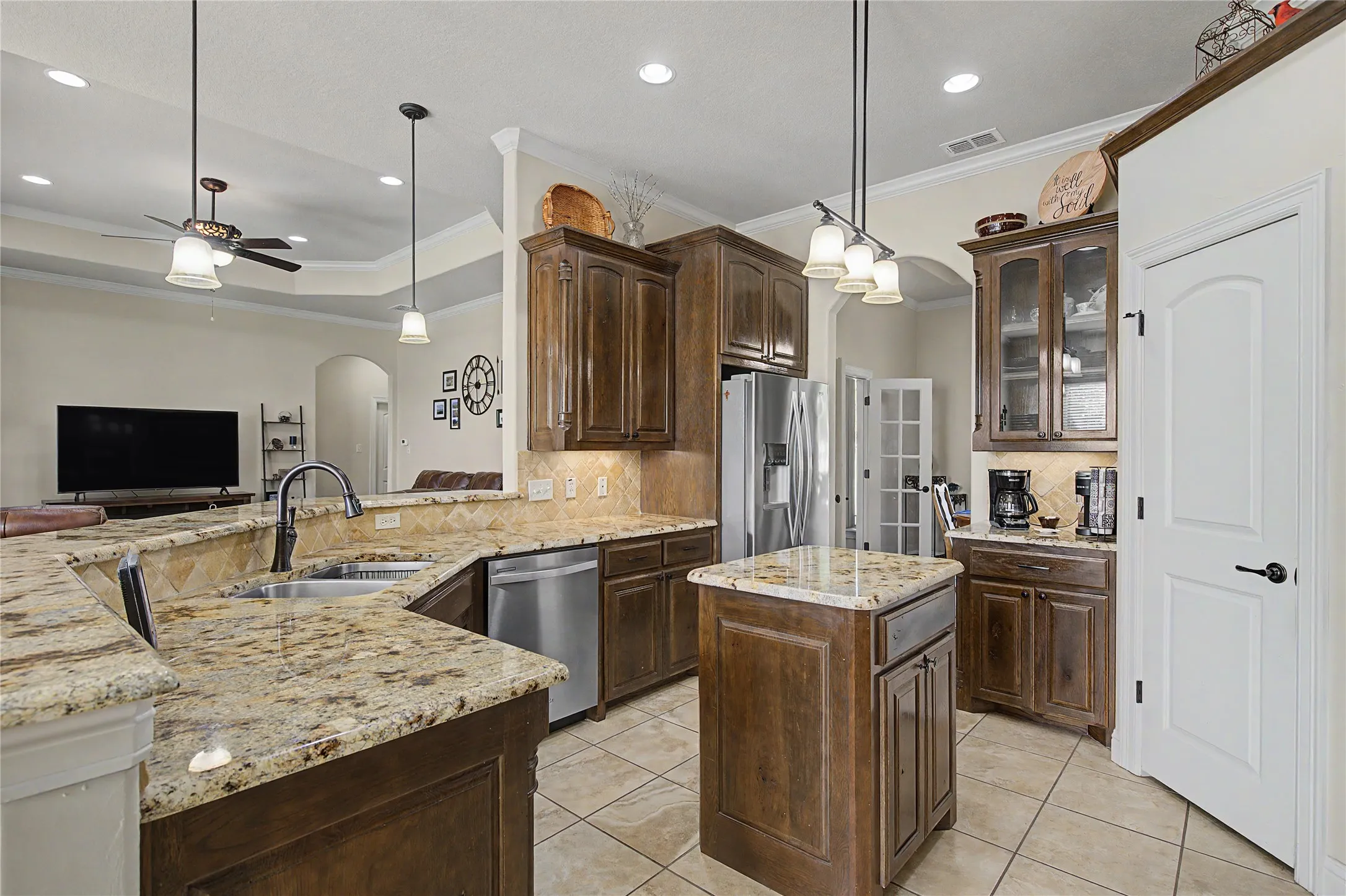 Decorative pendant and recessed lighting in kitchen and living space