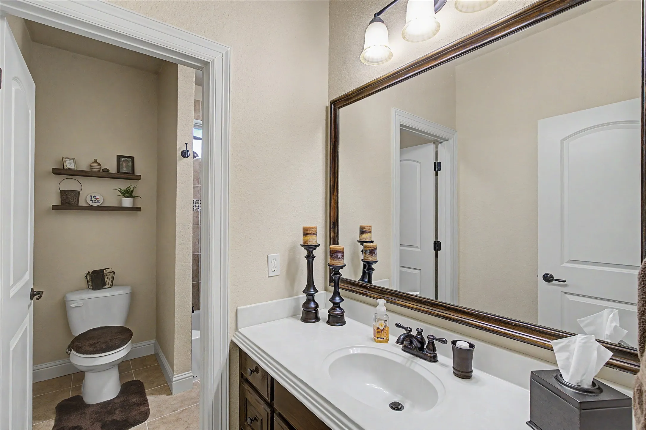 Guest bedrooms share jack-and-jill bathroom with separate vanities