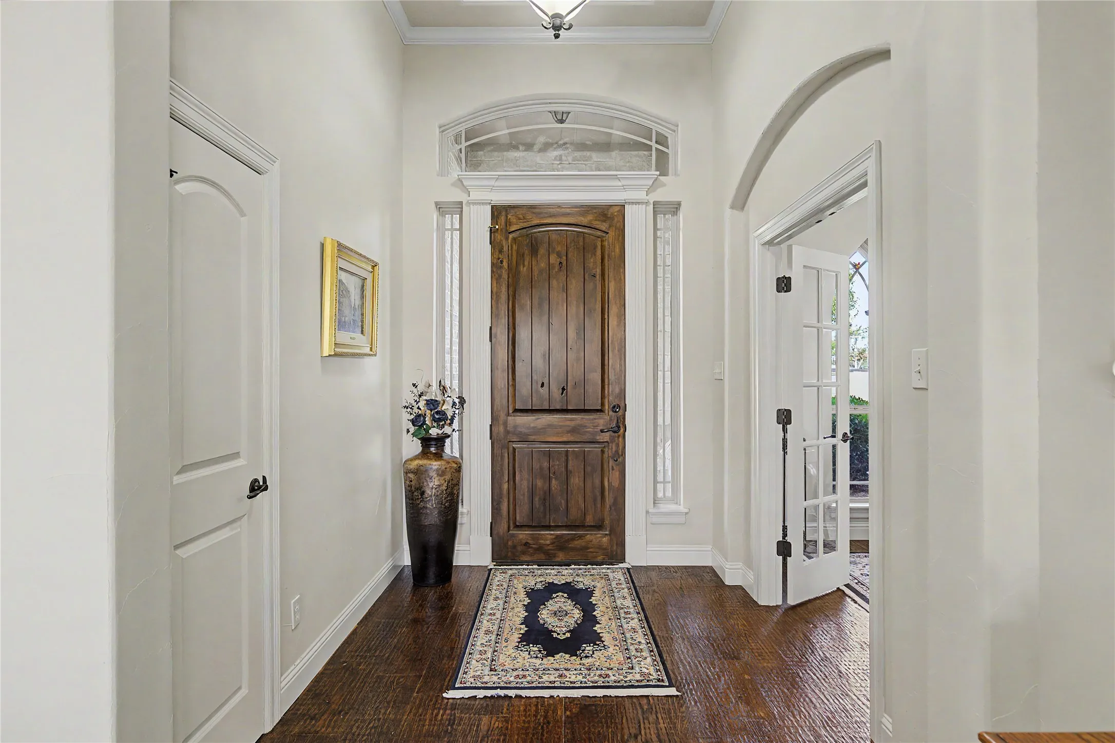 Grand Entry way with solid wood front door and high ceilings