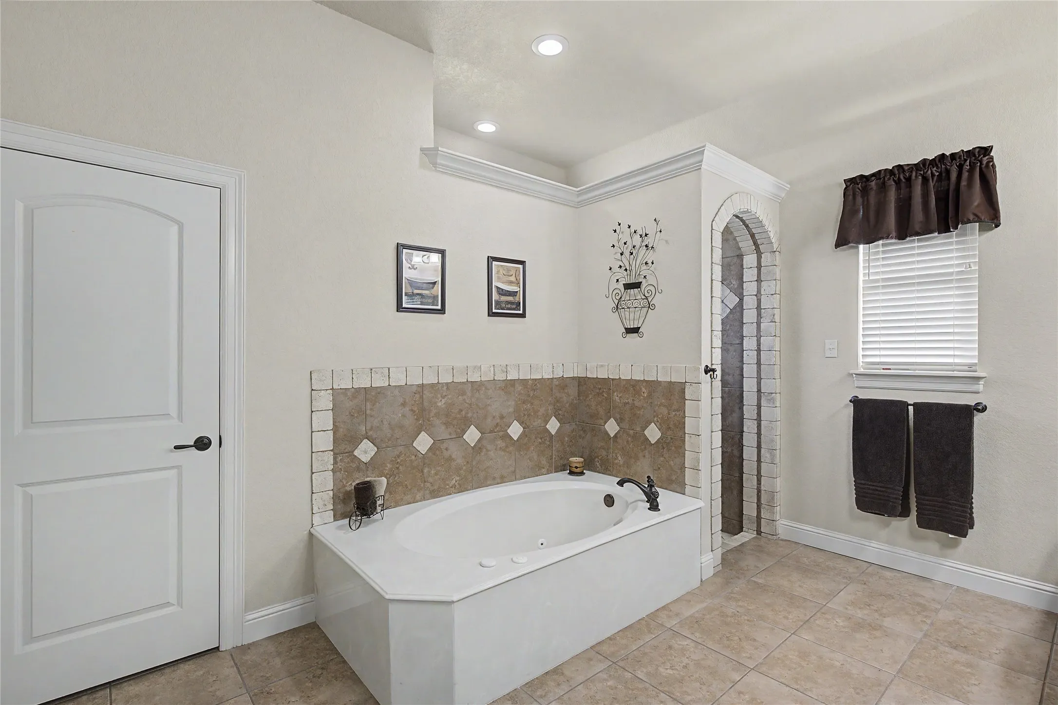Luxurious jetted tub in primary bathroom plus a separate shower