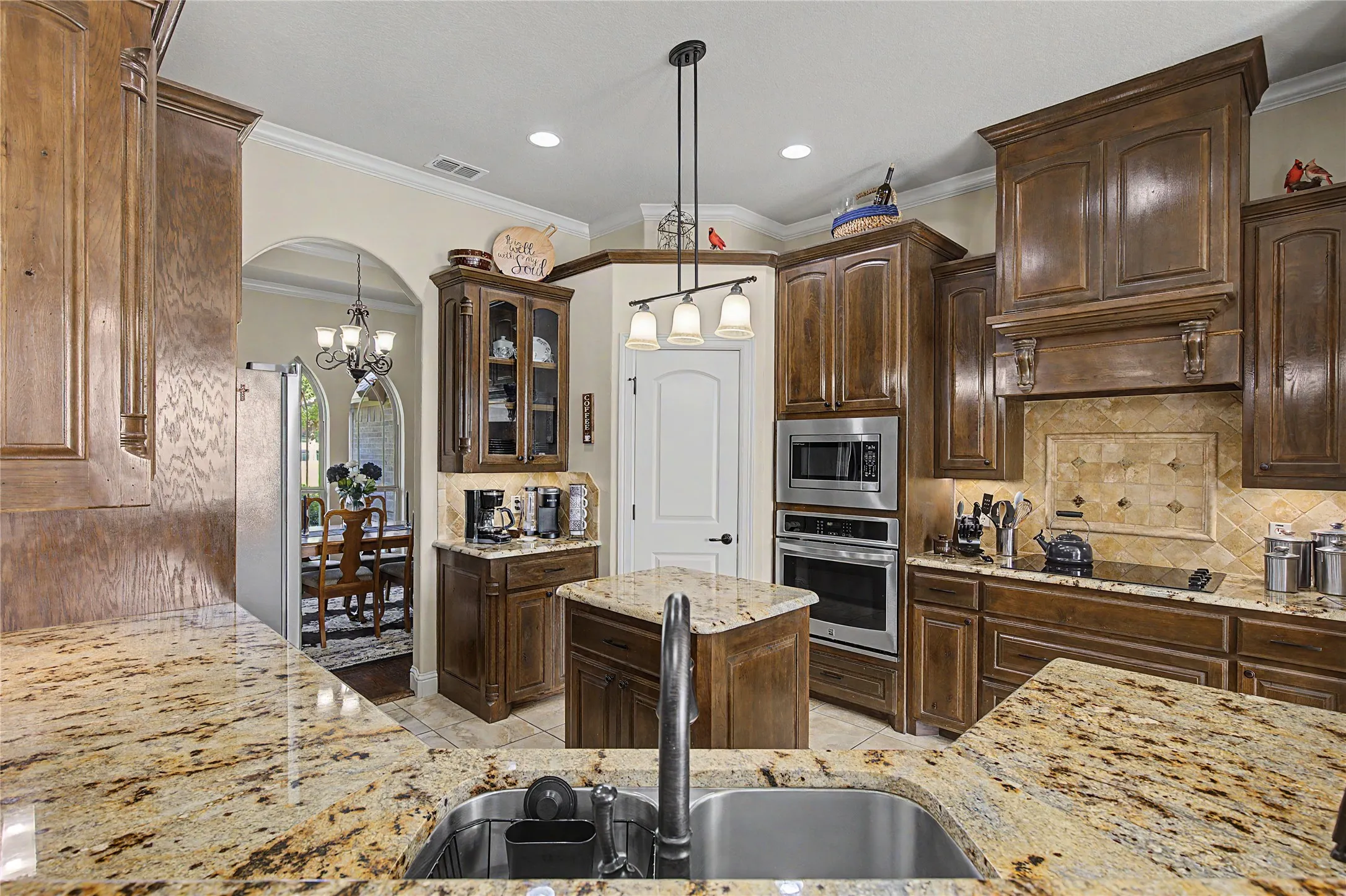 Chef's kitchen with granite countertops and wood cabinetry