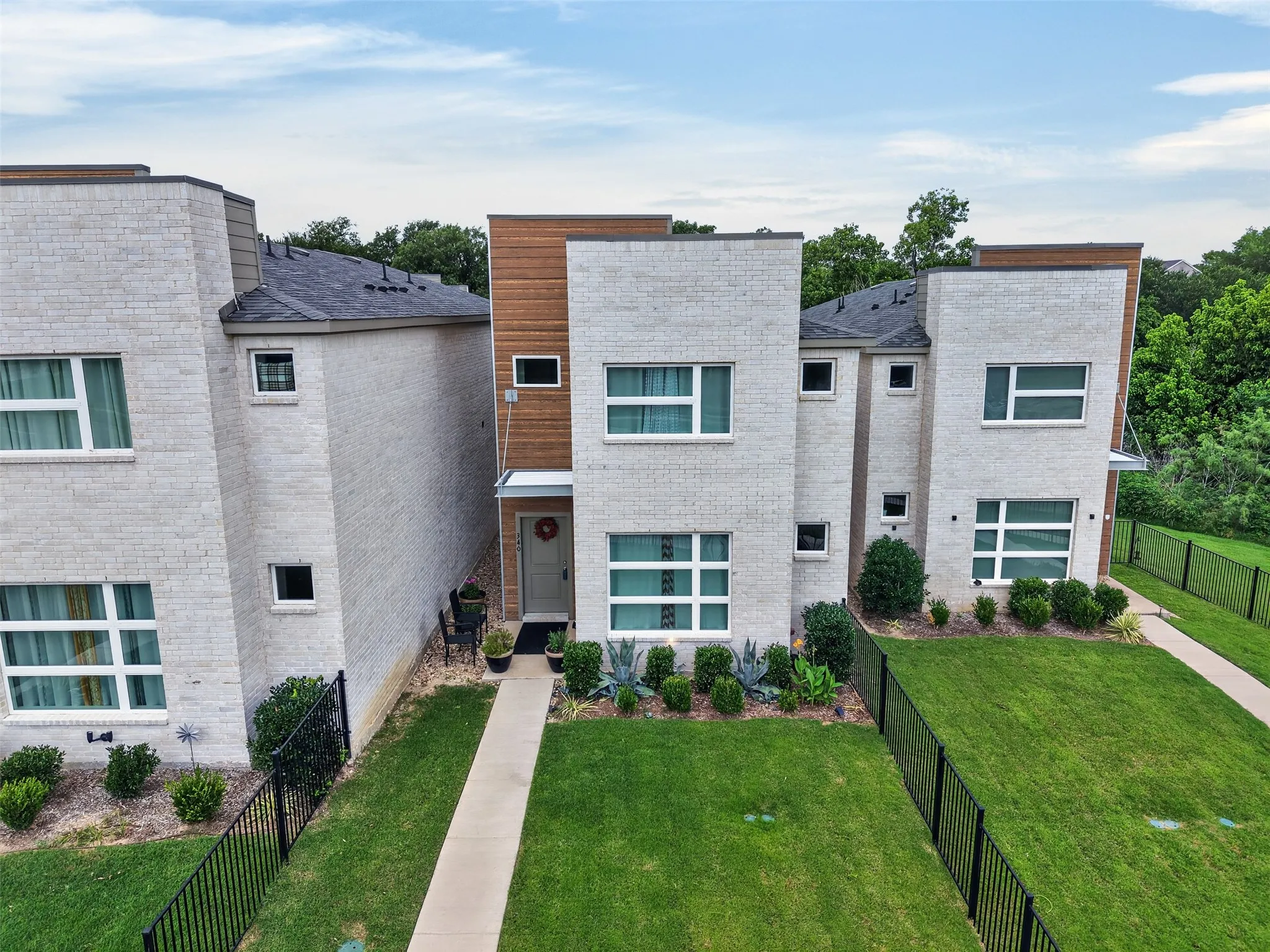 Aerial view showcasing the home’s modern architecture, clean lines, and beautifully maintained exterior.